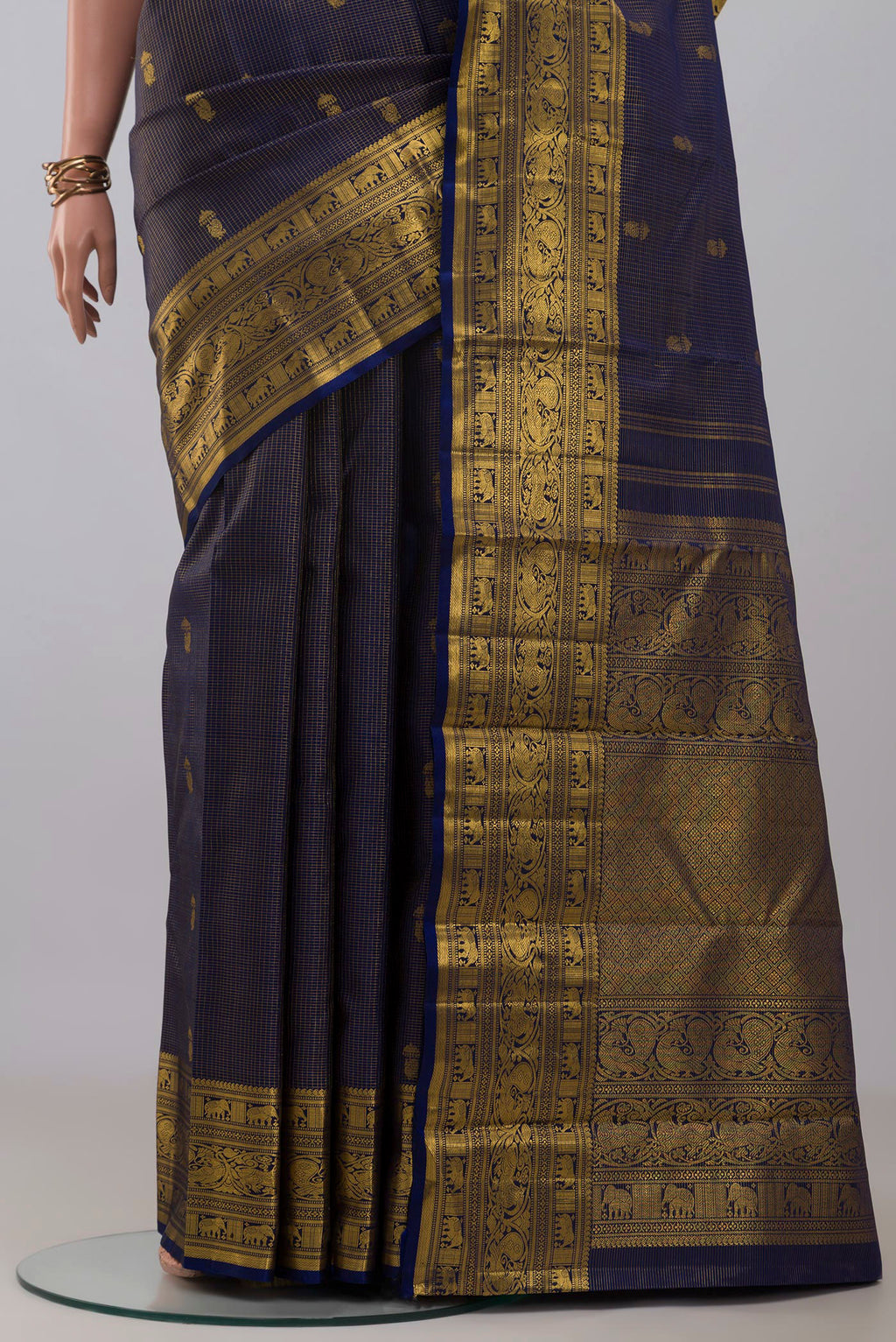 Pleats and pallu of Navy Blue Kanchipuram Silk Saree with Zari Butta on the body and Zari Border. 
