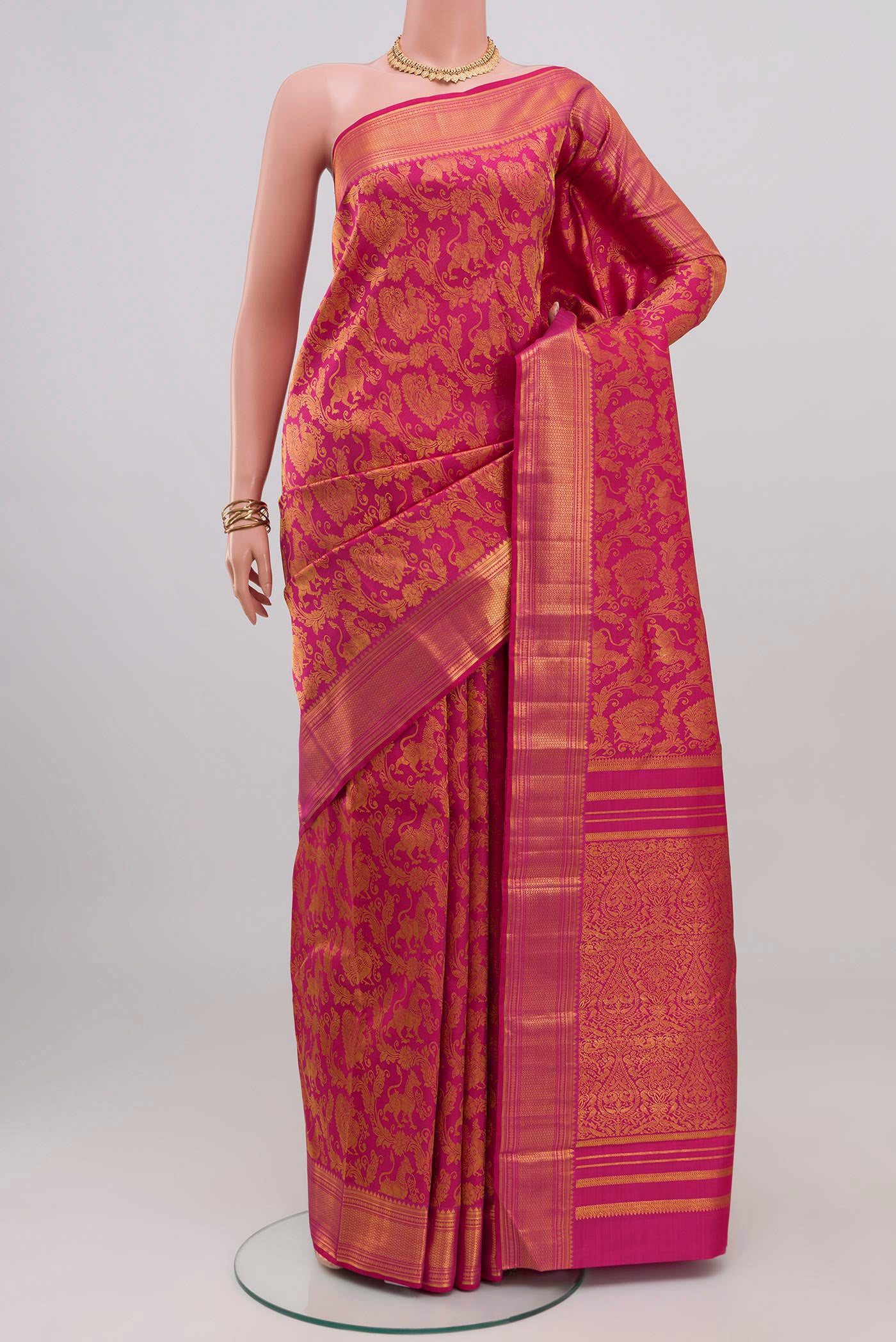 Pink Kanchipuram Silk Saree with Zari Brocade on the body and Zari Border.  displayed on a mannequin