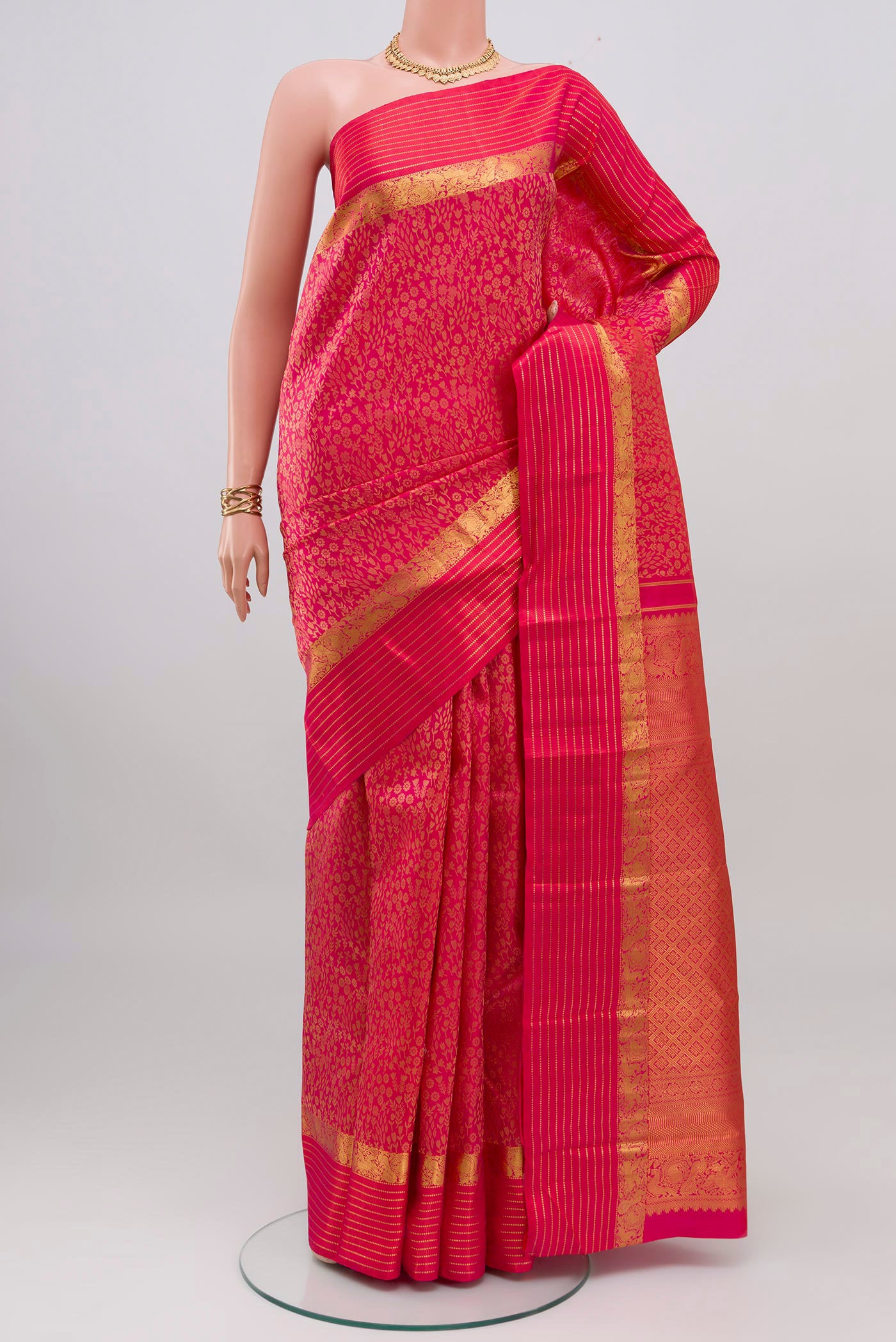 Pink Kanjivaram Silk Saree with Jacquard design on the body and Zari Border.  displayed on a mannequin