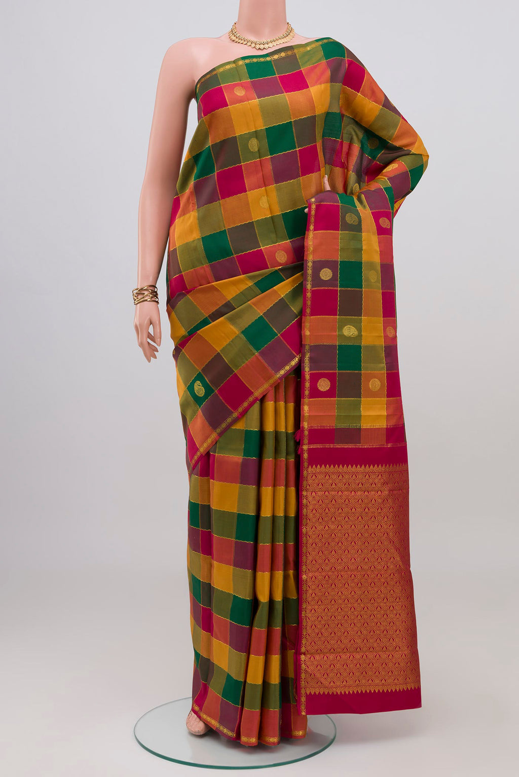 Multi Color Kanchipuram Silk Saree with Checked design on the body and Thin Zari Line.  displayed on a mannequin