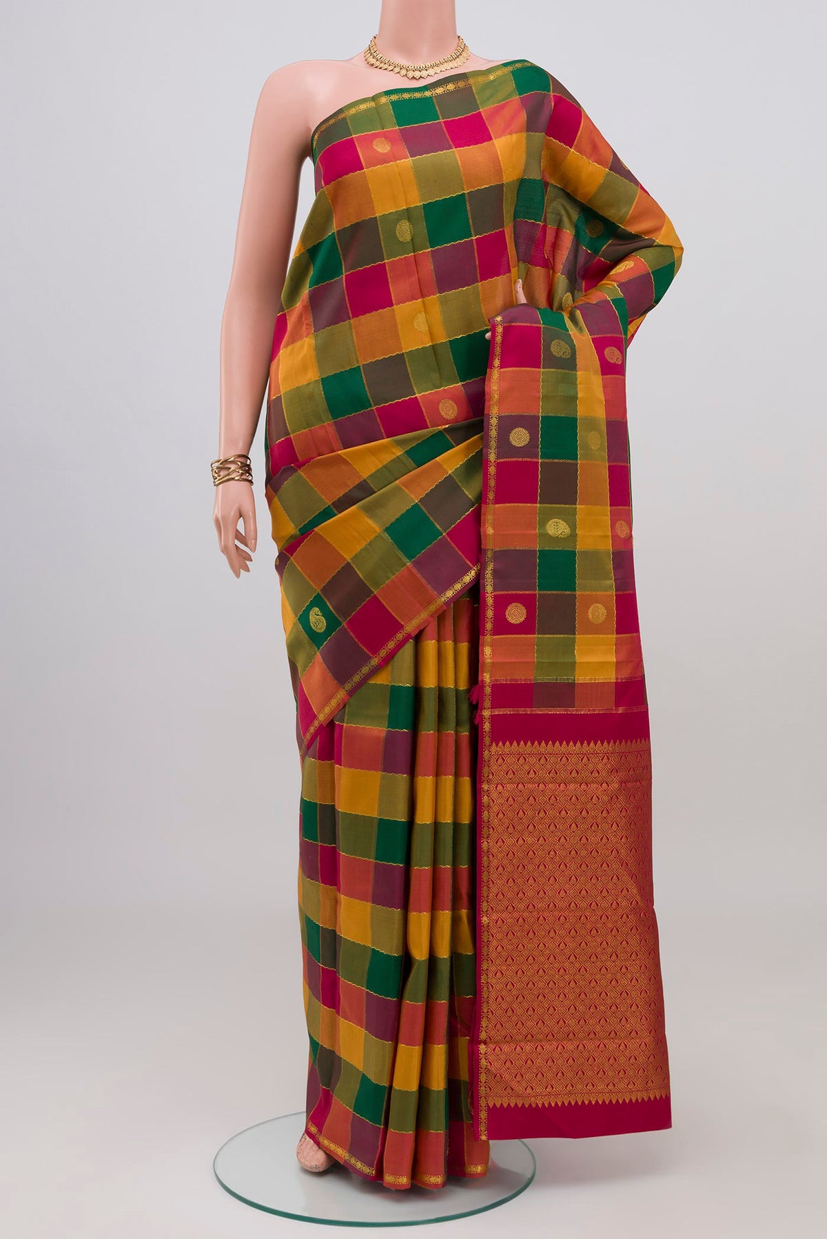Multi Color Kanchipuram Silk Saree with Checked design on the body and Thin Zari Line.  displayed on a mannequin