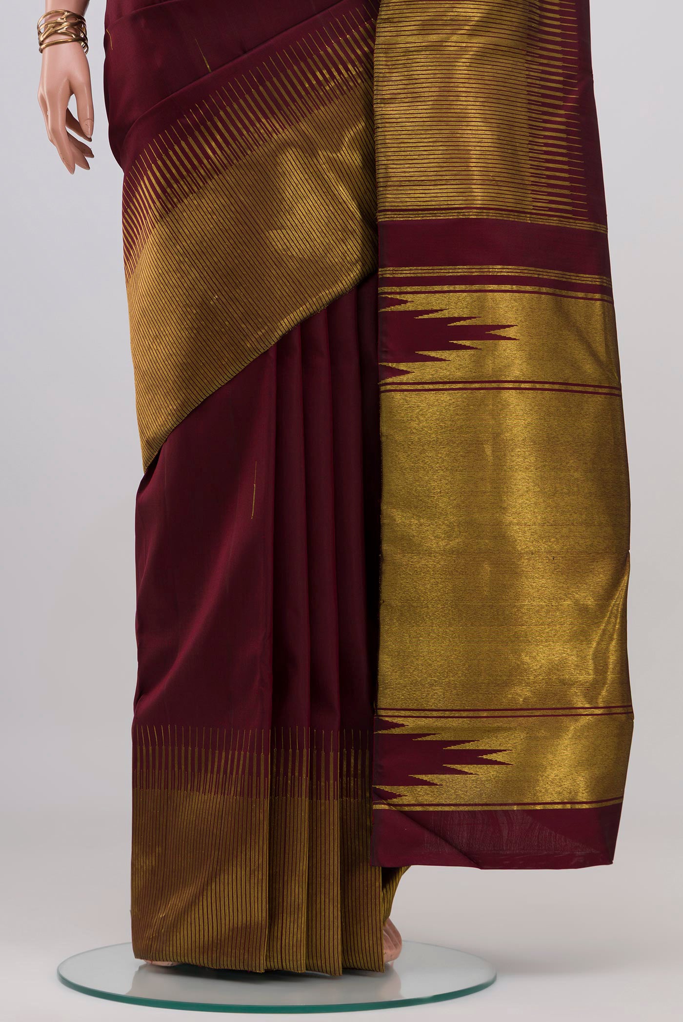 Pleats and pallu of Maroon Kanjivaram Silk Saree with Zari Butta on the body and Fancy Border. 