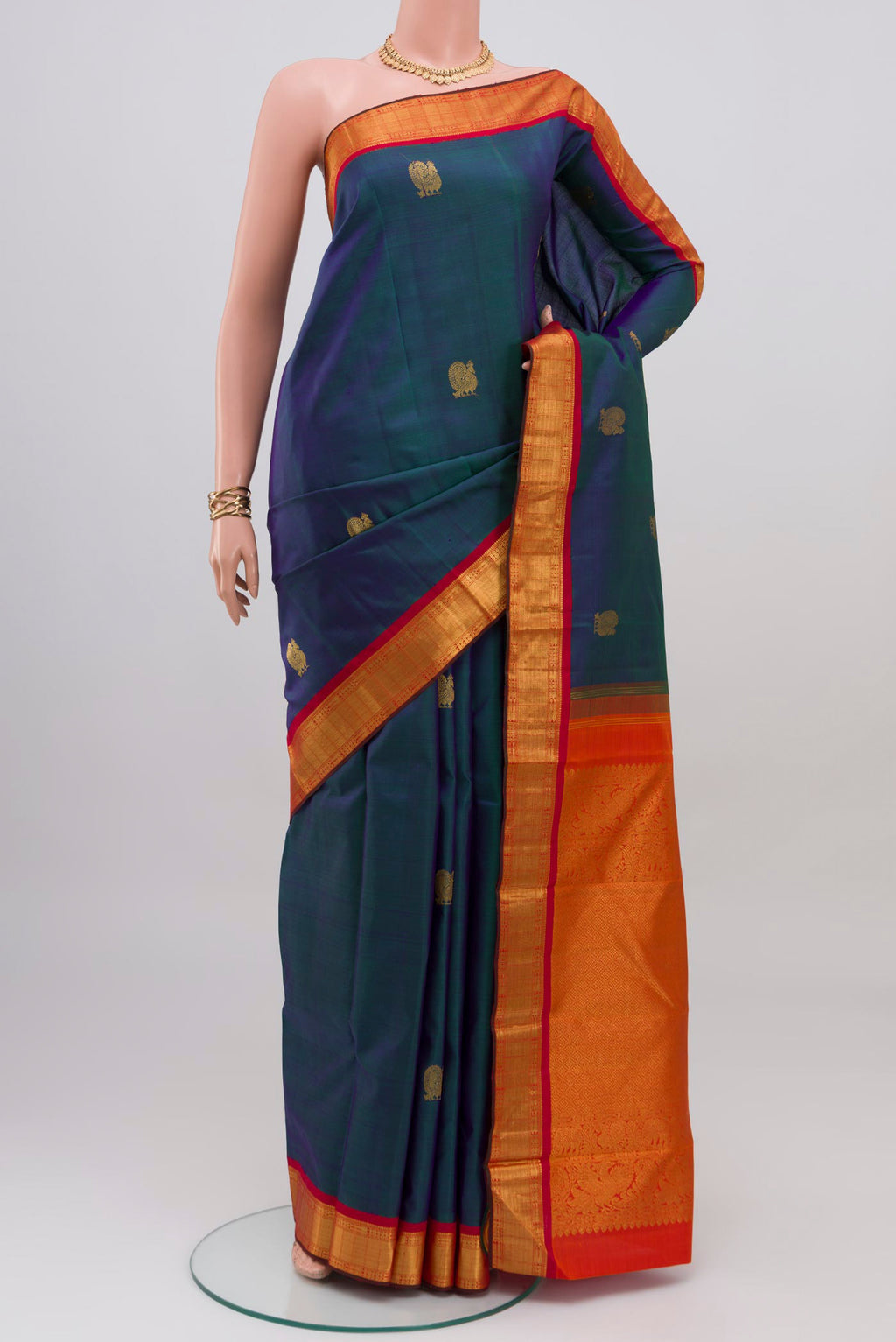 Peacock Blue Kanjivaram Silk Saree with Zig Zag design on the body and Zari Border.  displayed on a mannequin