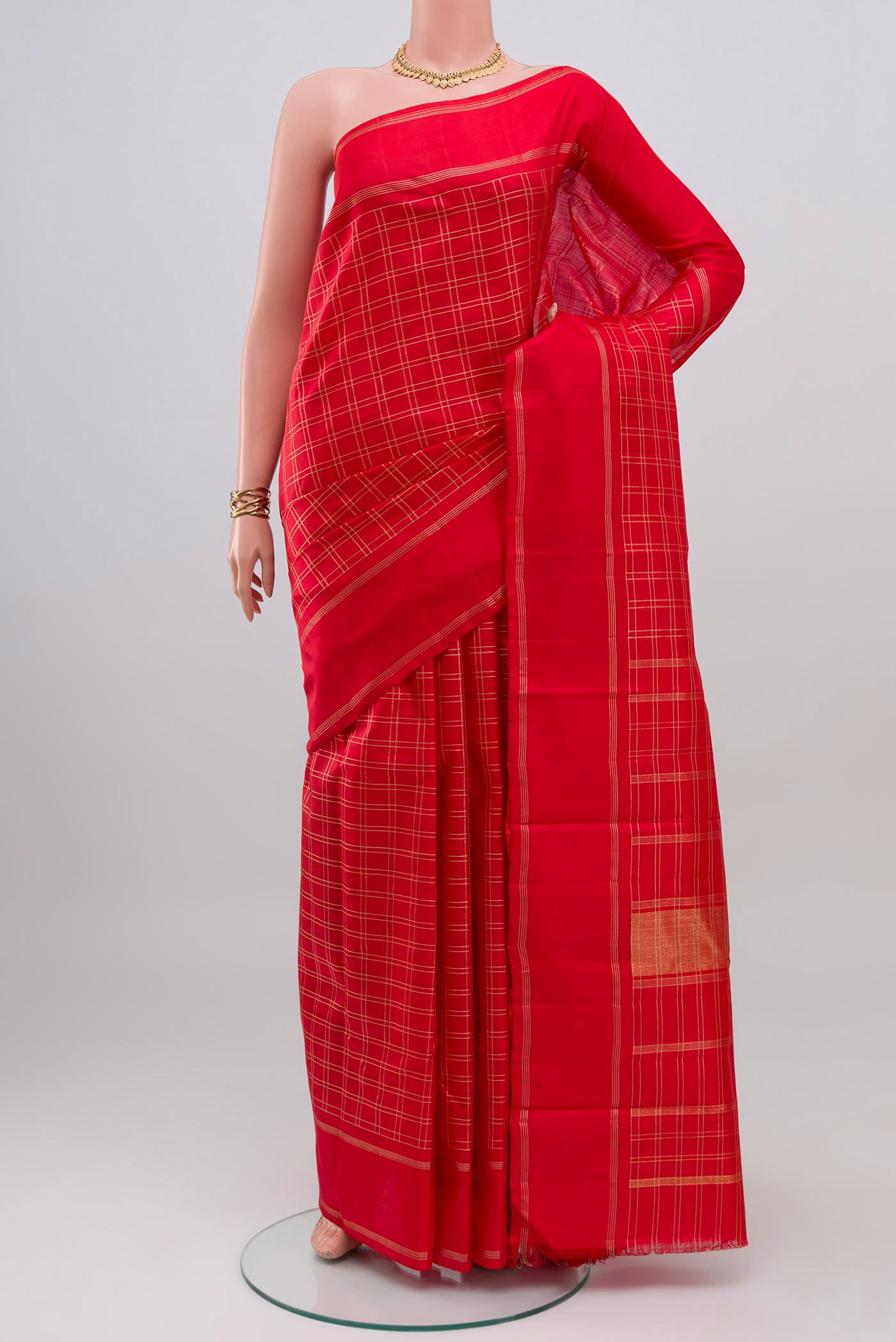 Red Kanchipuram Silk Saree with Checked design on the body and Plain Border.  displayed on a mannequin