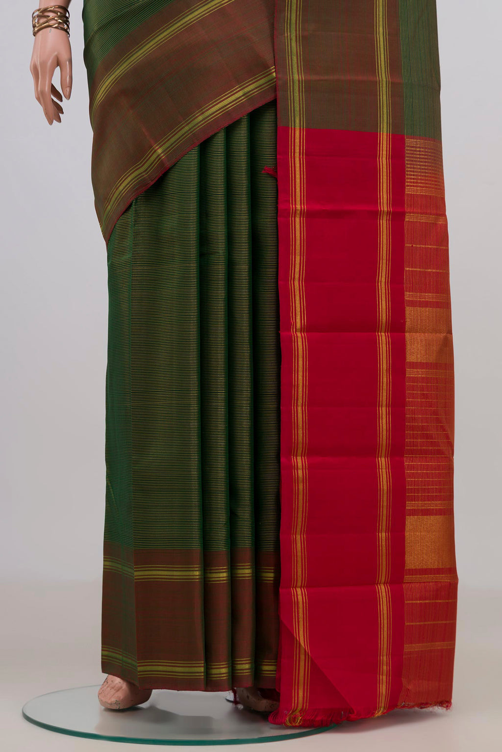Pleats and pallu of Pure Silk Green Kanchipuram Saree with Stripes on the body and Thin Zari Line. 