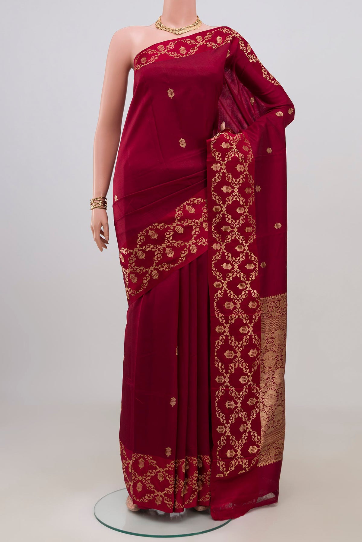 Maroon Banarasi Katan Silk Saree with Zari Butta on the body and Fancy Border.  displayed on a mannequin