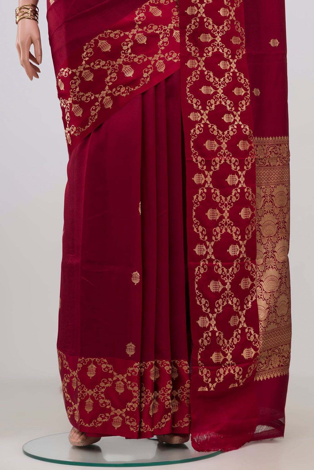 Pleats and pallu of Maroon Banarasi Katan Silk Saree with Zari Butta on the body and Fancy Border. 