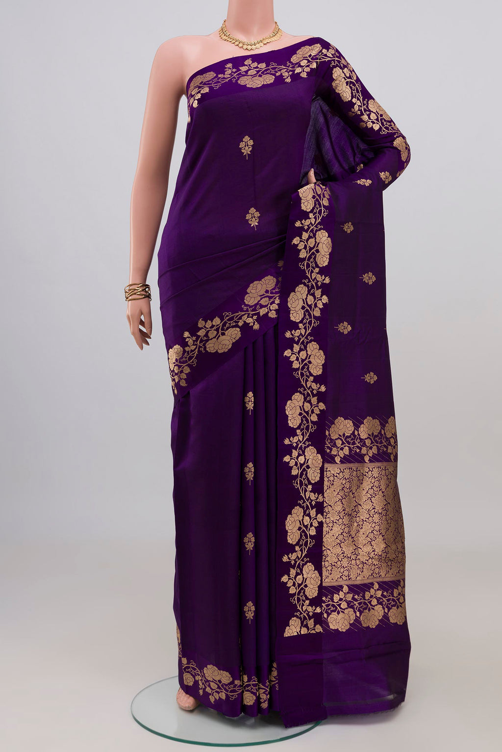 Violet Banarasi Katan Silk Saree with Zari Butta on the body and Fancy Border.  displayed on a mannequin