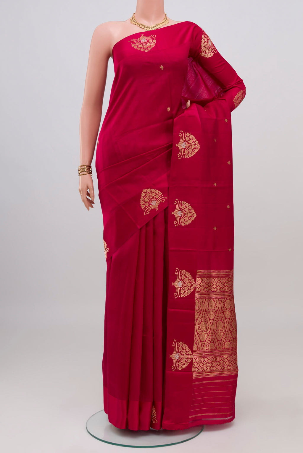 Maroon Banarasi Katan Silk Saree with Zari Butta on the body and Fancy Border.  displayed on a mannequin