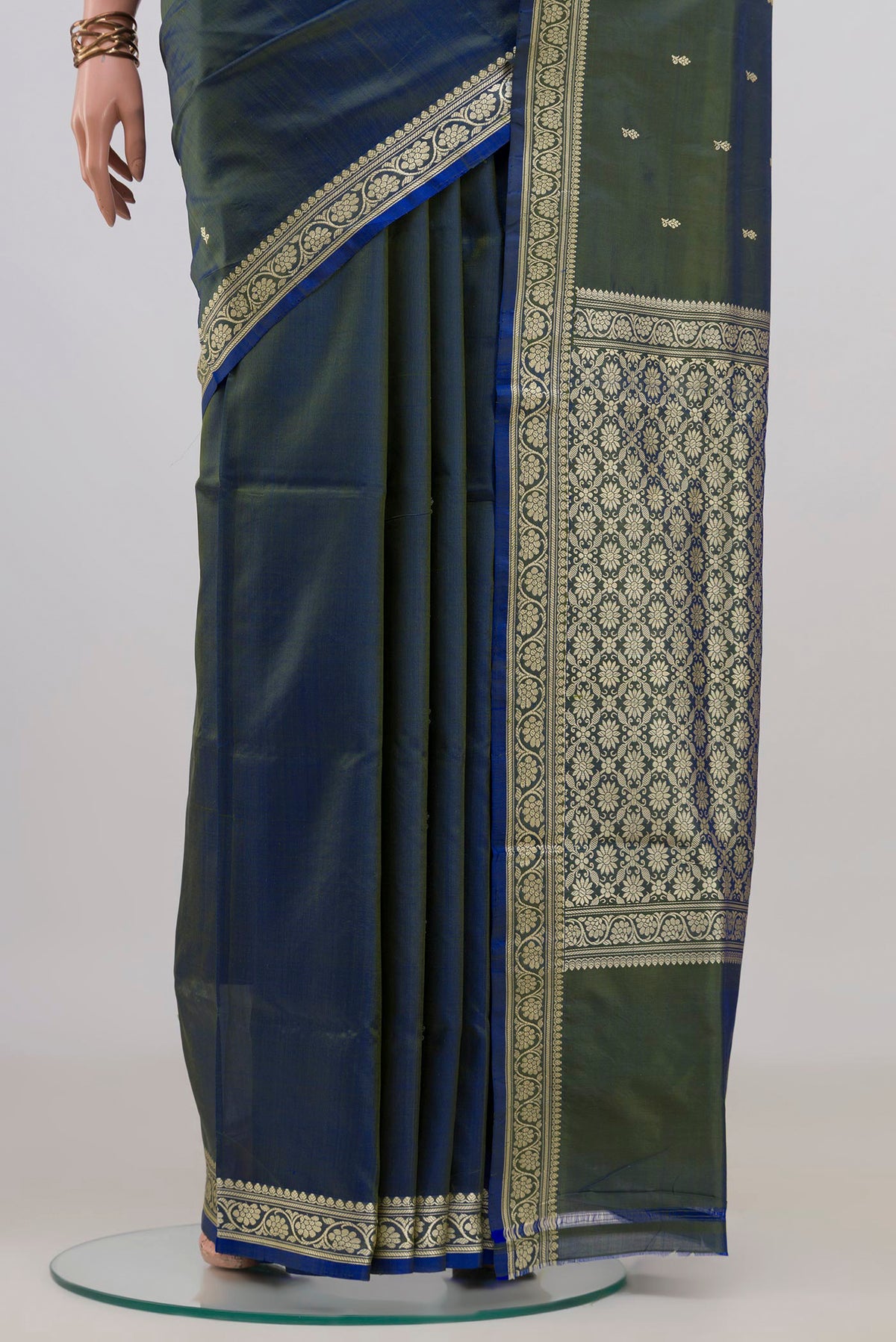Pleats and pallu of Pure Silk Blue with Green Color Banarasi Katan Saree with Thread Butta on the body and Thread Border. 