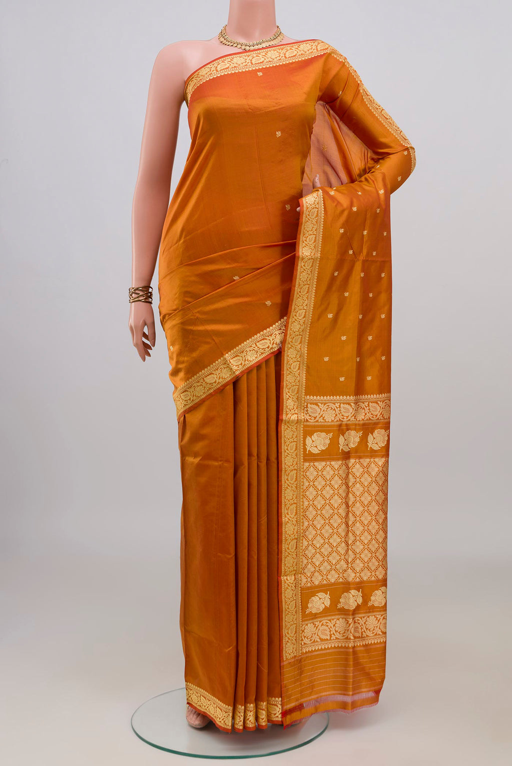 Pure Silk Mustard Banarasi Katan Saree with Thread Butta on the body and Thread Border.  displayed on a mannequin