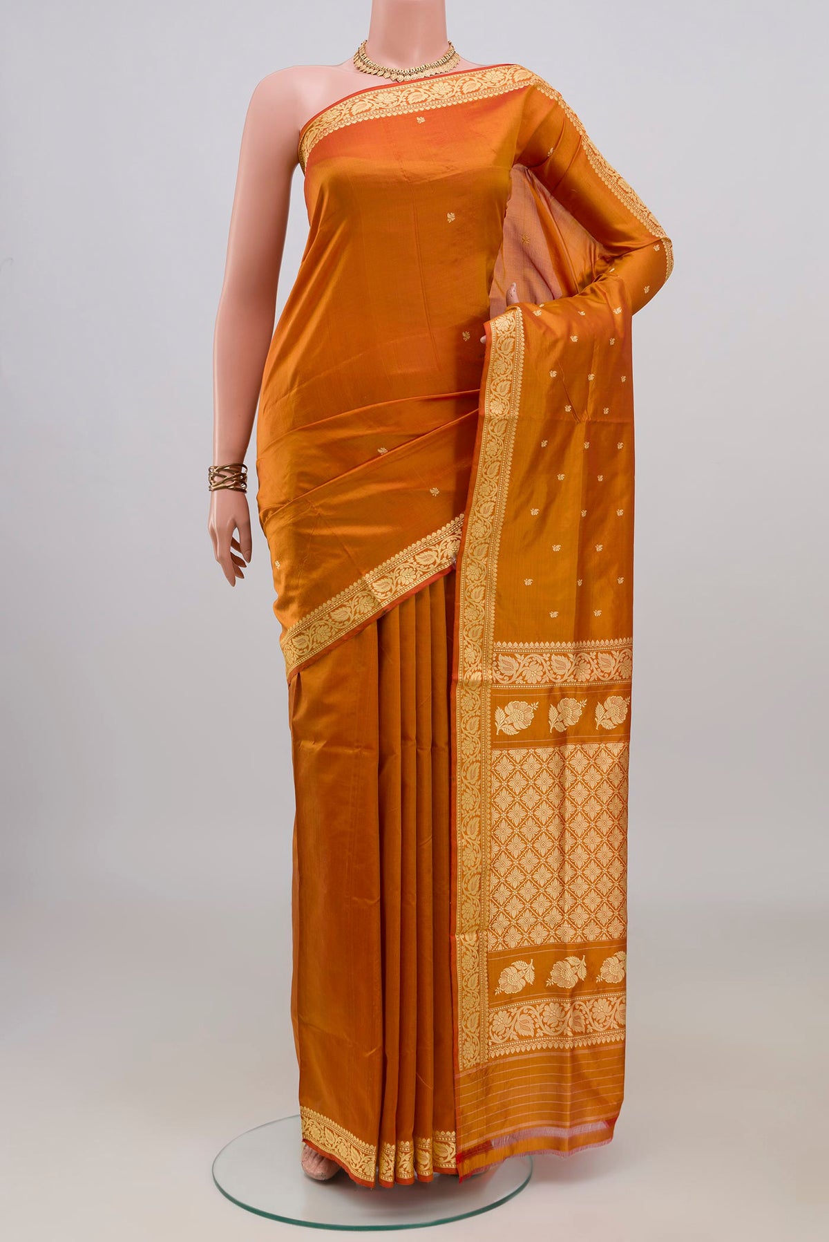 Pure Silk Mustard Banarasi Katan Saree with Thread Butta on the body and Thread Border.  displayed on a mannequin