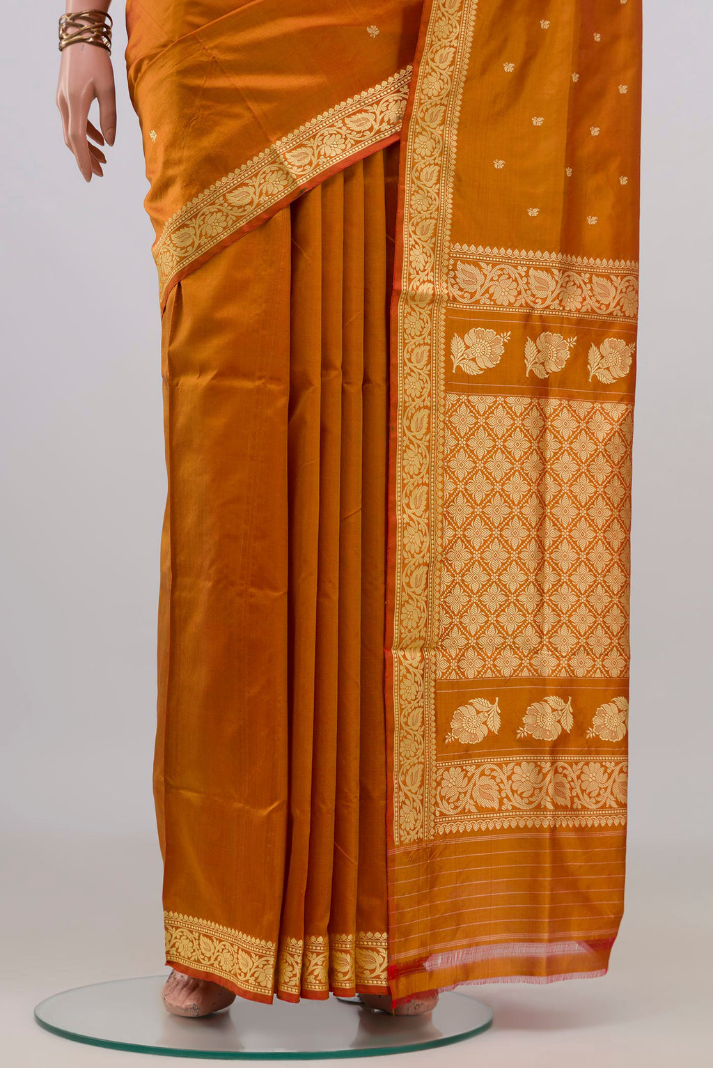 Pleats and pallu of Pure Silk Mustard Banarasi Katan Saree with Thread Butta on the body and Thread Border. 