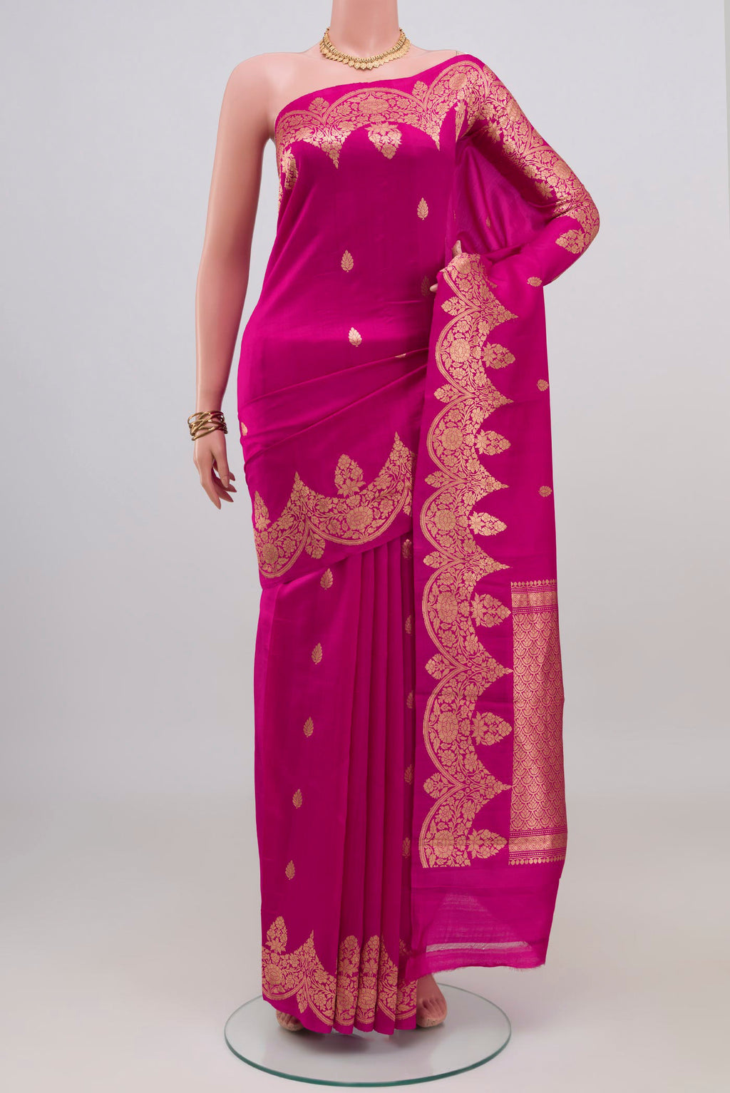 Rani Pink Banarasi Katan Silk Saree with Zari Butta on the body and Fancy Border.  displayed on a mannequin