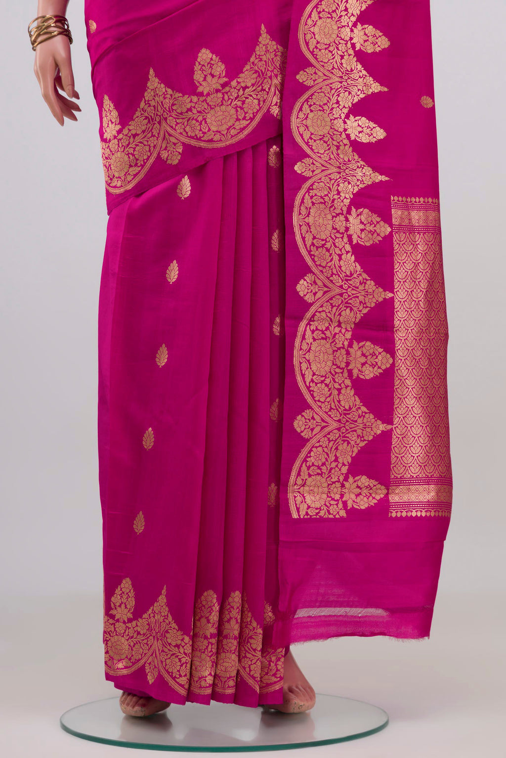 Pleats and pallu of Rani Pink Banarasi Katan Silk Saree with Zari Butta on the body and Fancy Border. 