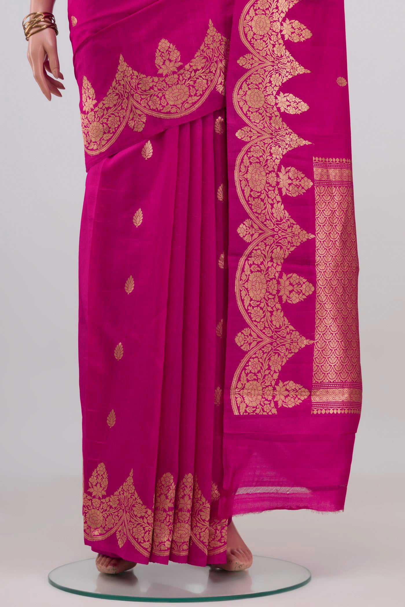 Pleats and pallu of Rani Pink Banarasi Katan Silk Saree with Zari Butta on the body and Fancy Border. 