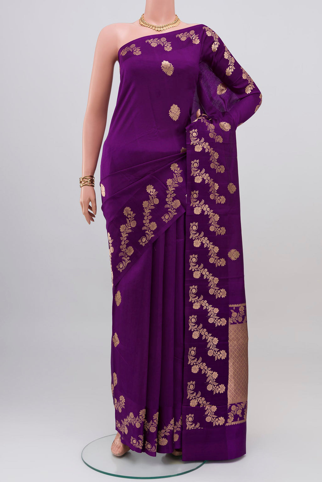 Violet Banarasi Katan Silk Saree with Zari Butta on the body and Fancy Border.  displayed on a mannequin