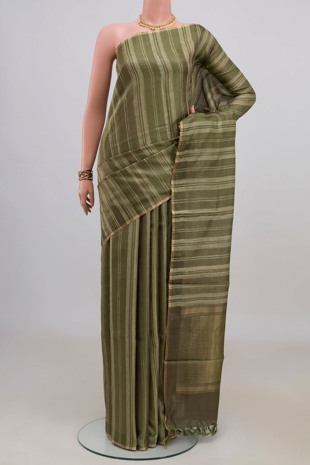 Mehandi Green Tussar Saree with Stripes on the body and Thin Zari Line.  displayed on a mannequin