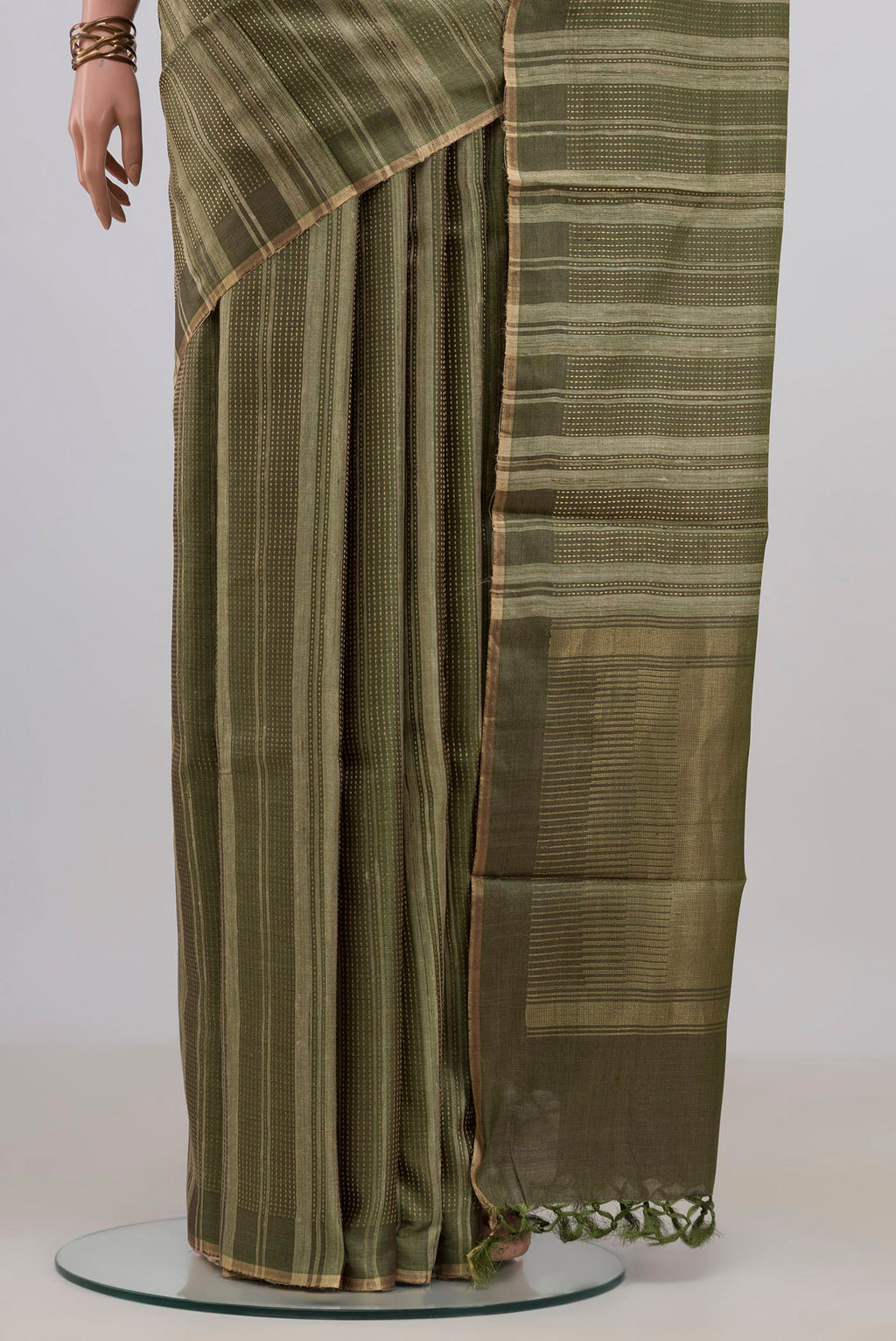 Pleats and pallu of Mehandi Green Tussar Saree with Stripes on the body and Thin Zari Line. 