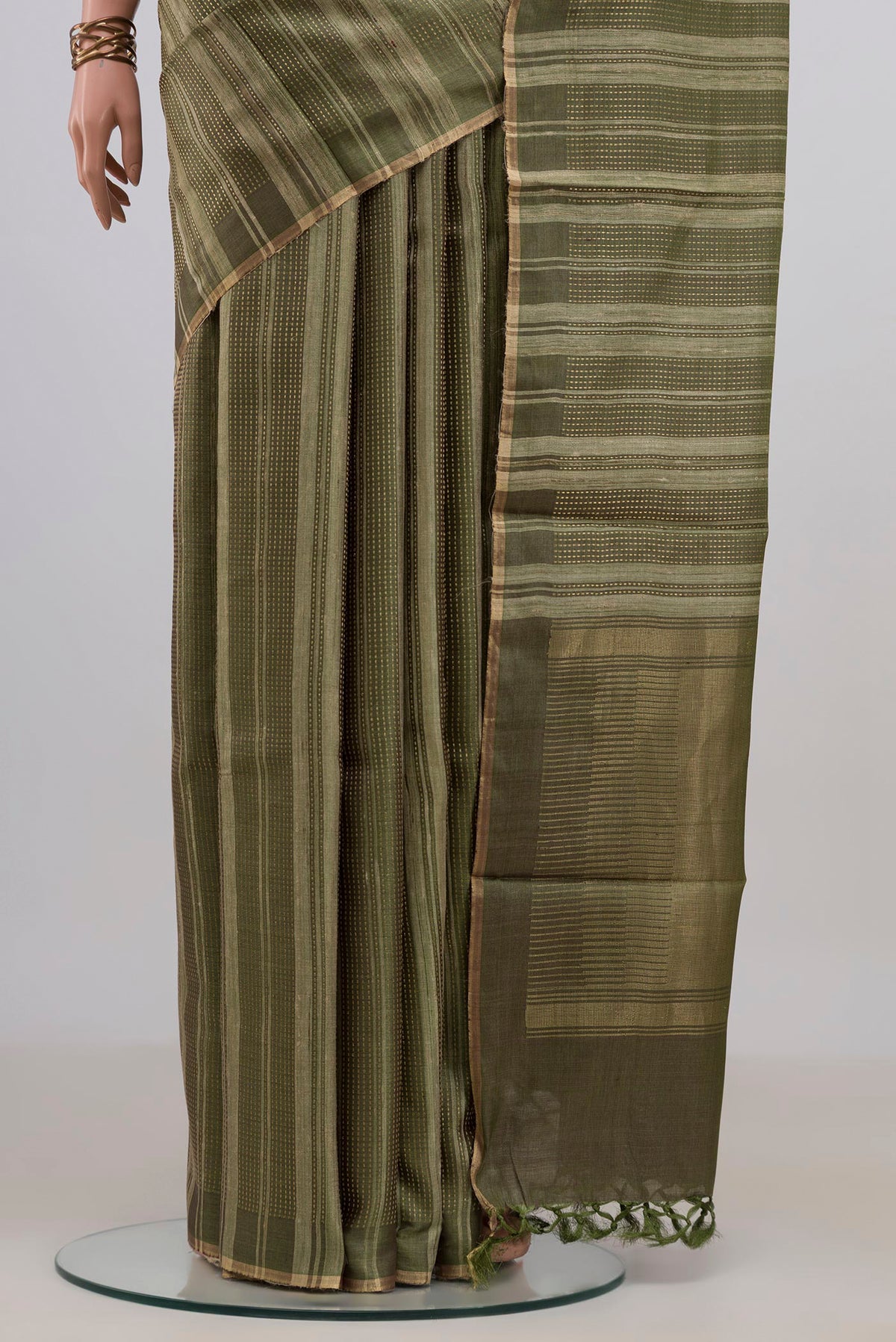Pleats and pallu of Mehandi Green Tussar Saree with Stripes on the body and Thin Zari Line. 