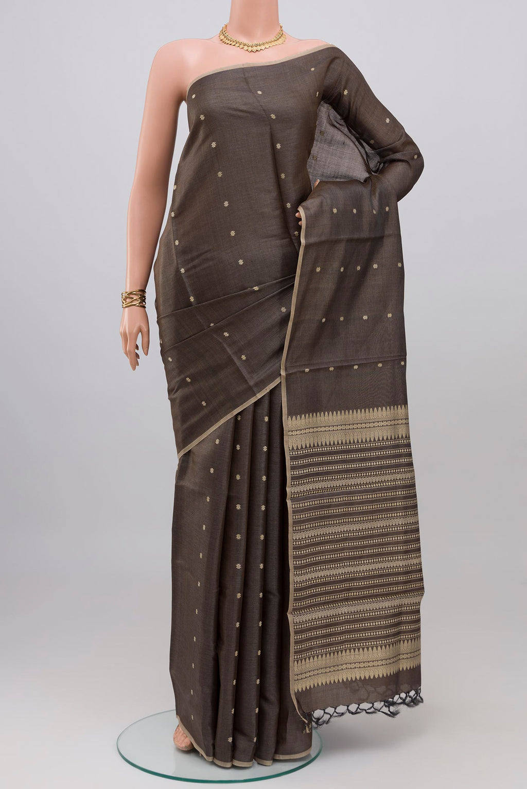 Grey Tussar Silk Saree with Thread Butta on the body and Without Border.  displayed on a mannequin