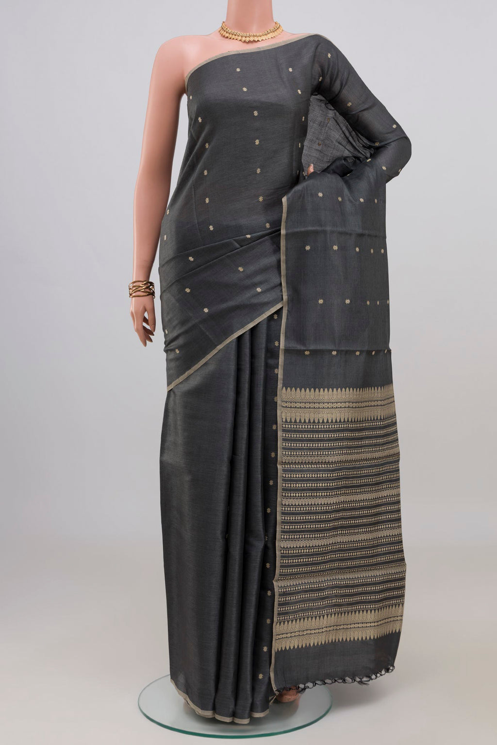 Grey Tussar Silk Saree with Thread Butta on the body and Without Border.  displayed on a mannequin