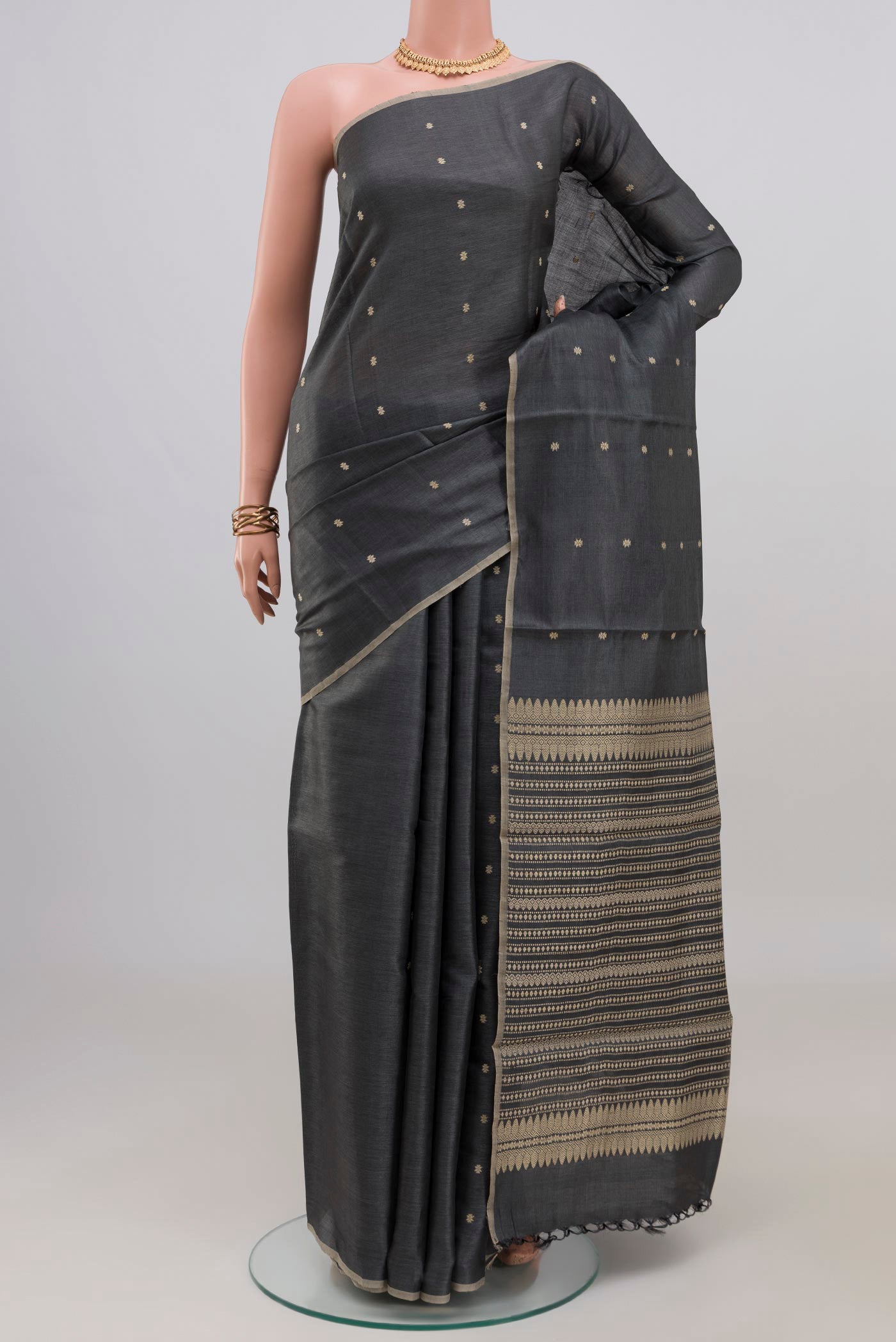 Grey Tussar Silk Saree with Thread Butta on the body and Without Border.  displayed on a mannequin