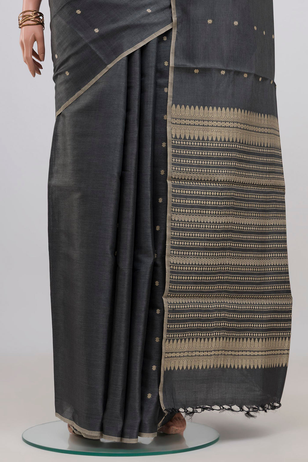 Pleats and pallu of Grey Tussar Silk Saree with Thread Butta on the body and Without Border. 