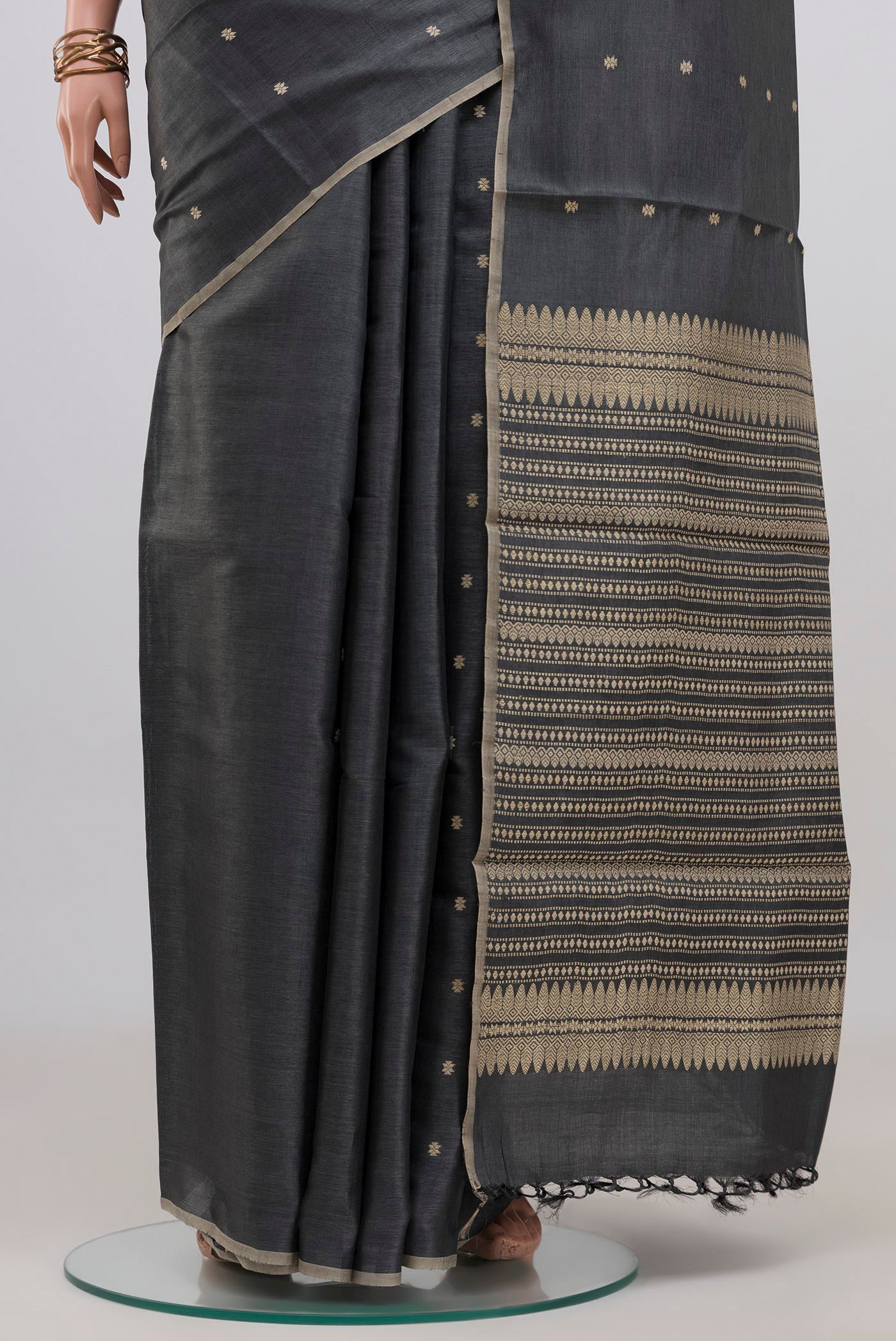 Pleats and pallu of Grey Tussar Silk Saree with Thread Butta on the body and Without Border. 