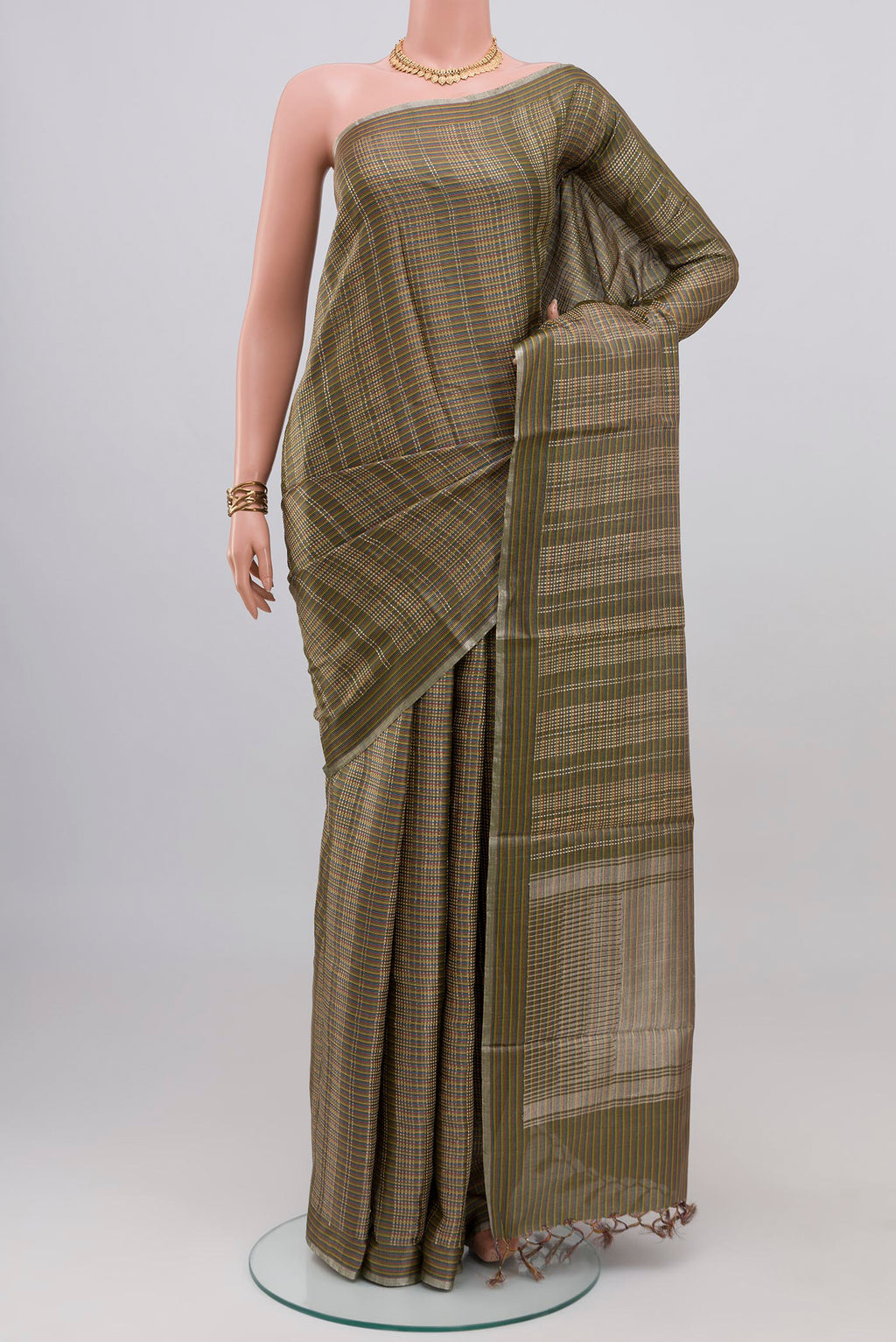 Green Tussar Silk Saree with Checked design on the body and Thin Zari Line.  displayed on a mannequin