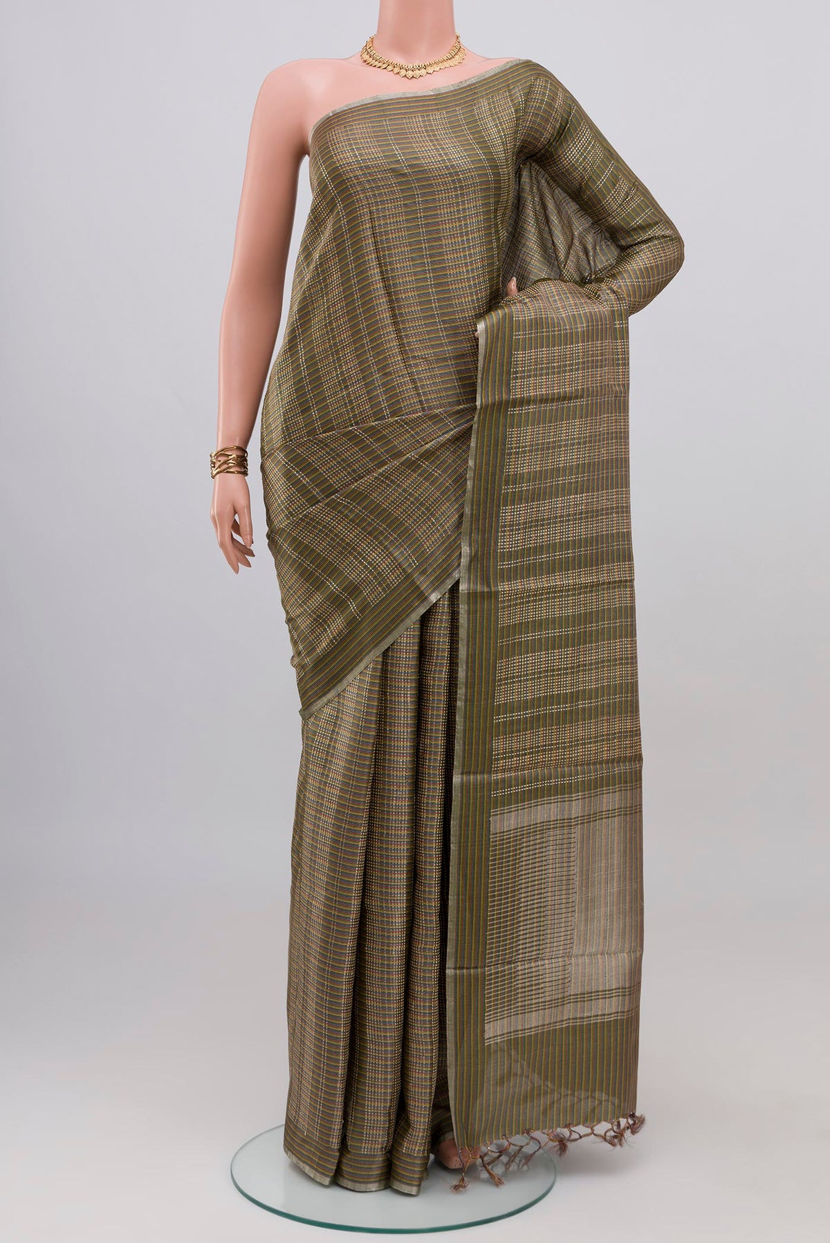 Green Tussar Silk Saree with Checked design on the body and Thin Zari Line.  displayed on a mannequin