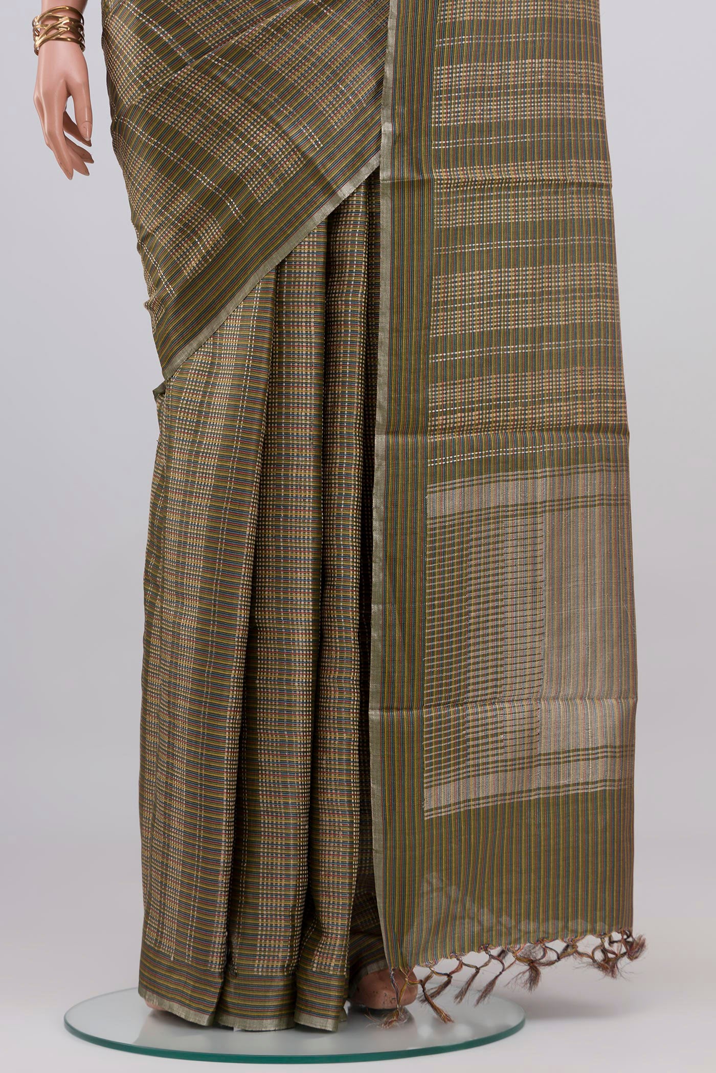 Pleats and pallu of Green Tussar Silk Saree with Checked design on the body and Thin Zari Line. 