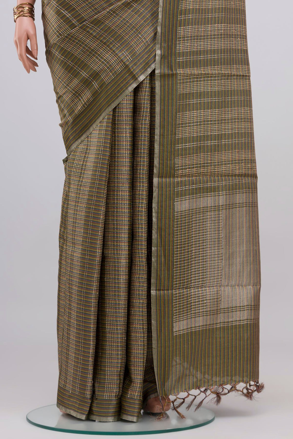 Pleats and pallu of Green Tussar Silk Saree with Checked design on the body and Thin Zari Line. 