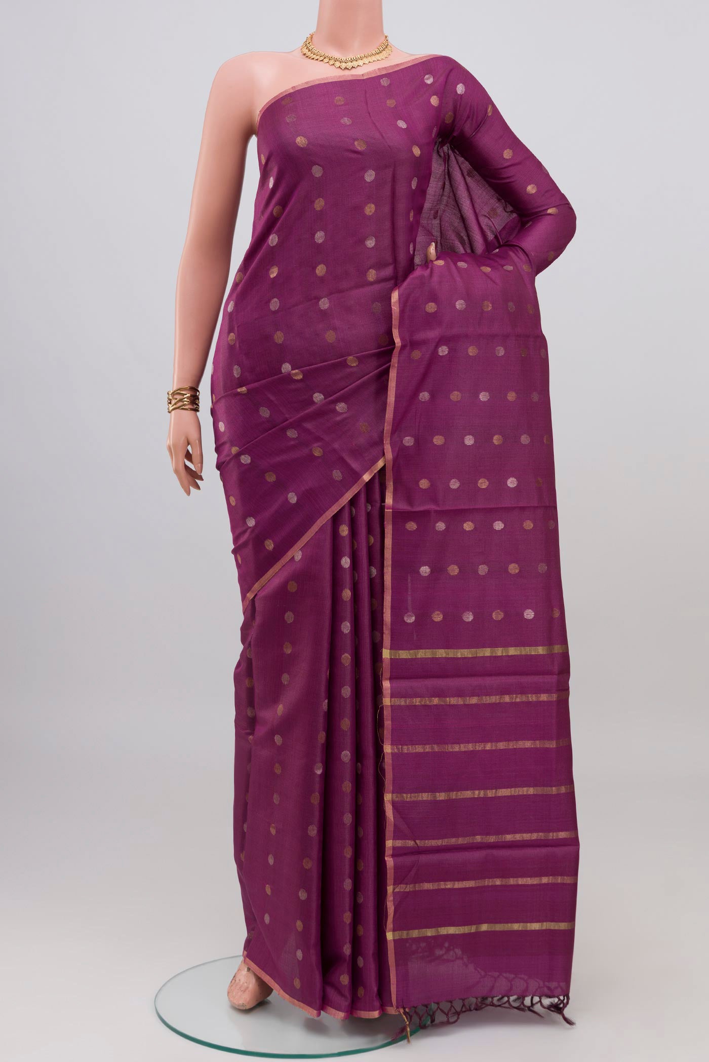 Purple Tussar Silk Saree with Zari Butta on the body and Thin Zari Line.  displayed on a mannequin