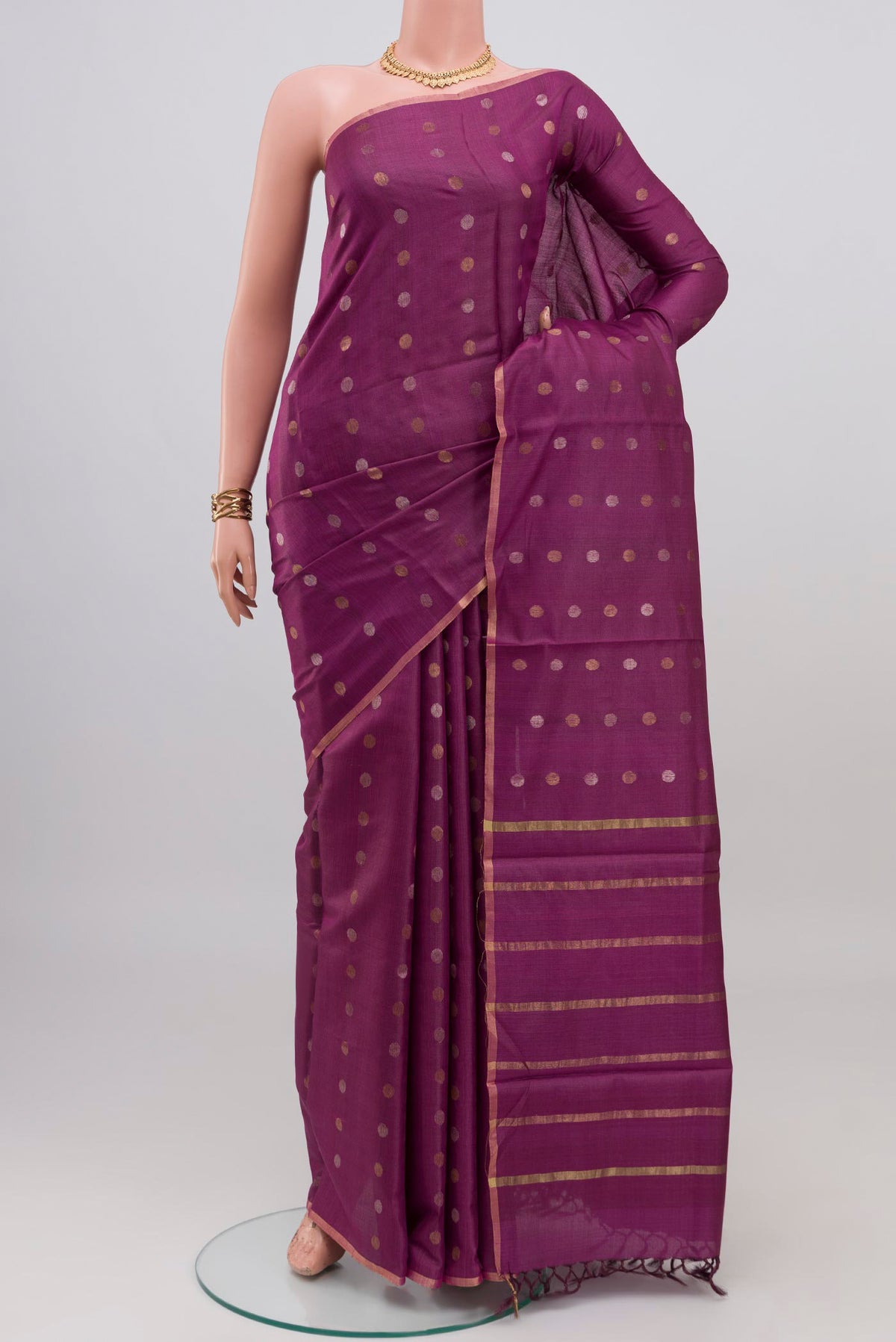 Purple Tussar Silk Saree with Zari Butta on the body and Thin Zari Line.  displayed on a mannequin
