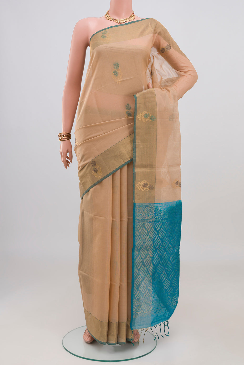 Cream Silk Cotton Saree with Zari And Thread Butta on the body and Zari Border.  displayed on a mannequin