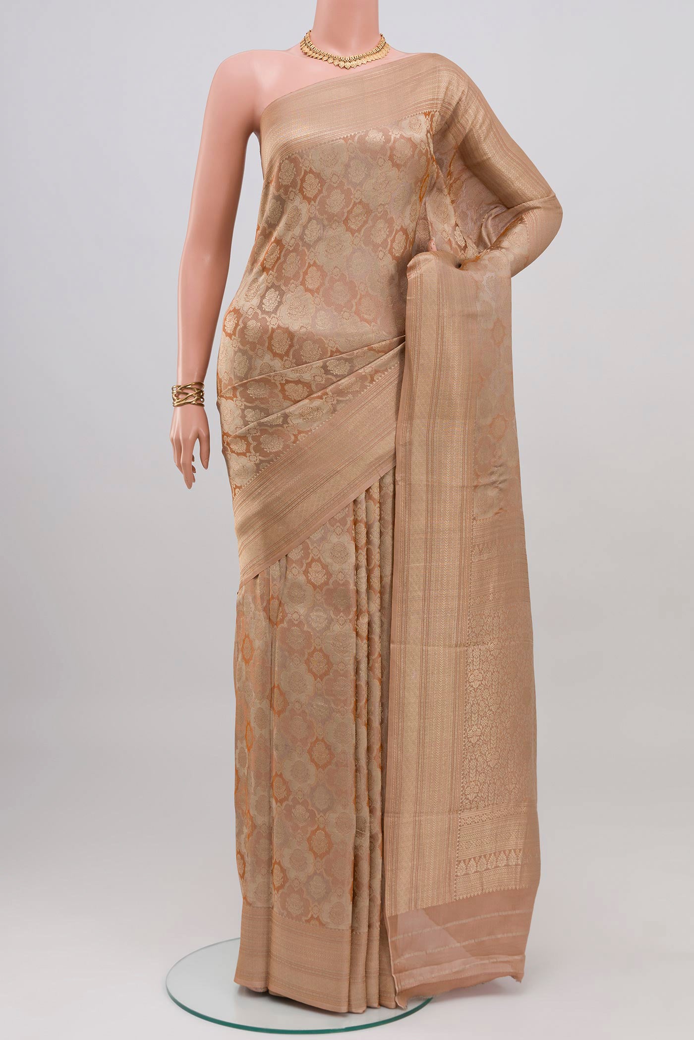 Rose Gold Crepe Saree with Zari Brocade on the body and Zari Border.  displayed on a mannequin