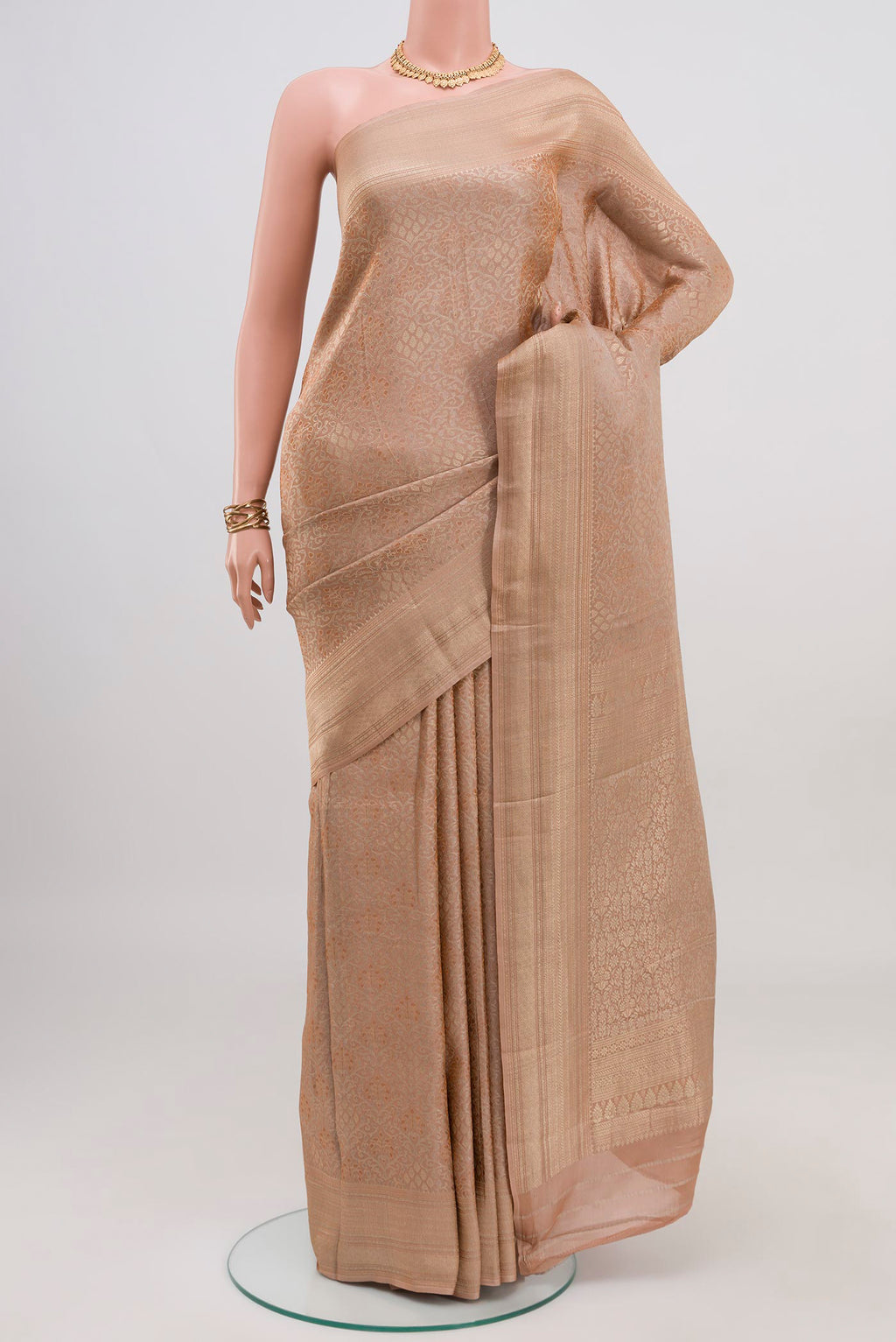 Beige Crepe Saree with Fancy on the body and Fancy Border.  displayed on a mannequin