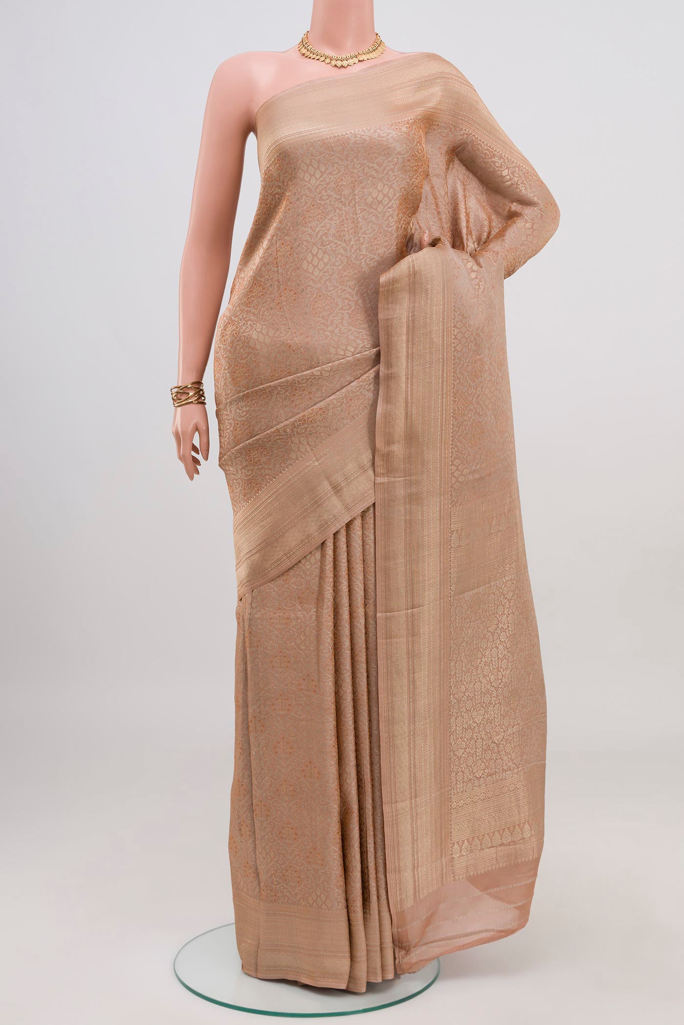 Beige Crepe Saree with Fancy on the body and Fancy Border.  displayed on a mannequin