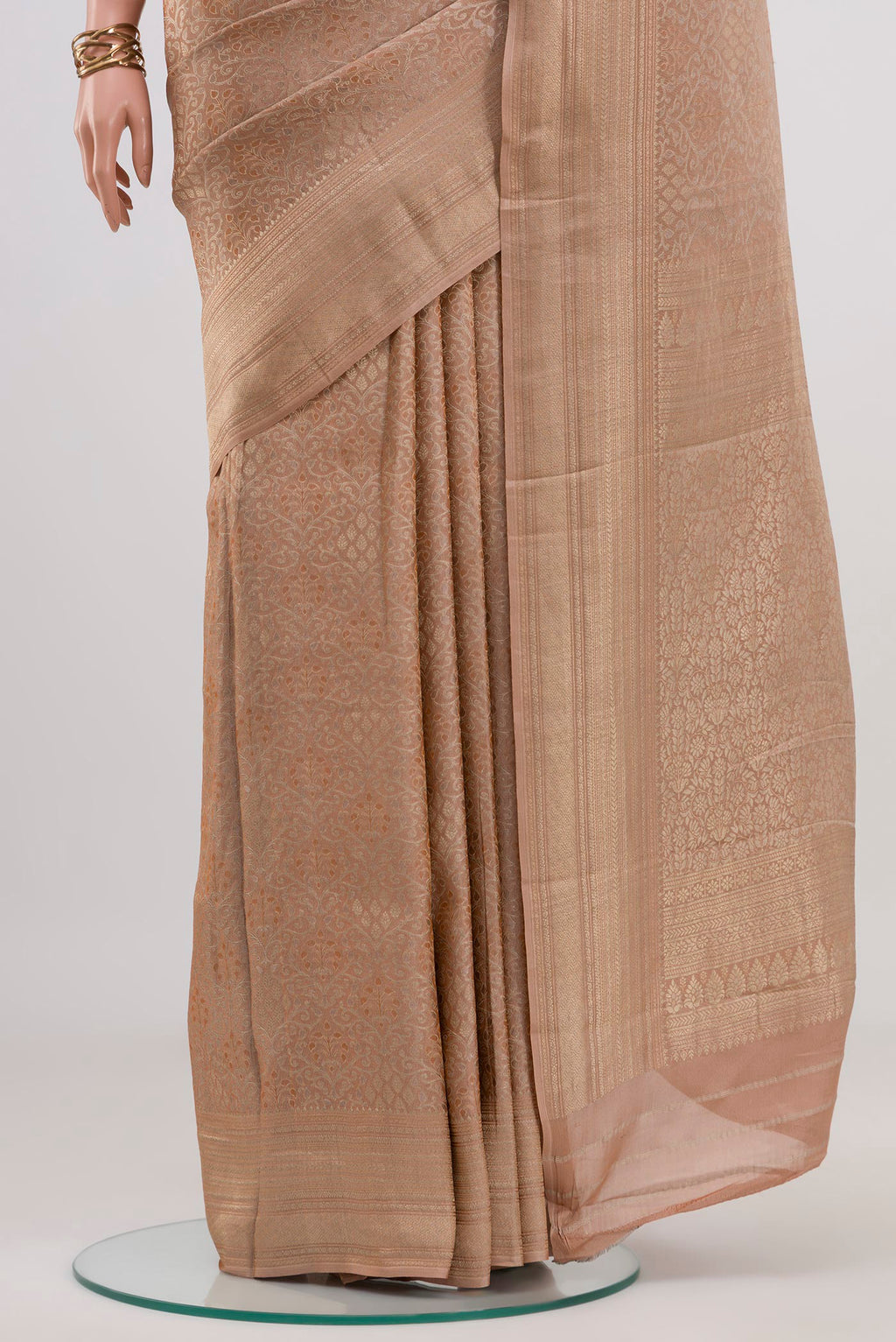Pleats and pallu of Beige Crepe Saree with Fancy on the body and Fancy Border. 