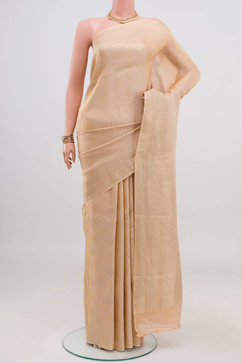 Beige Crepe Saree with Fancy on the body and Fancy Border.  displayed on a mannequin