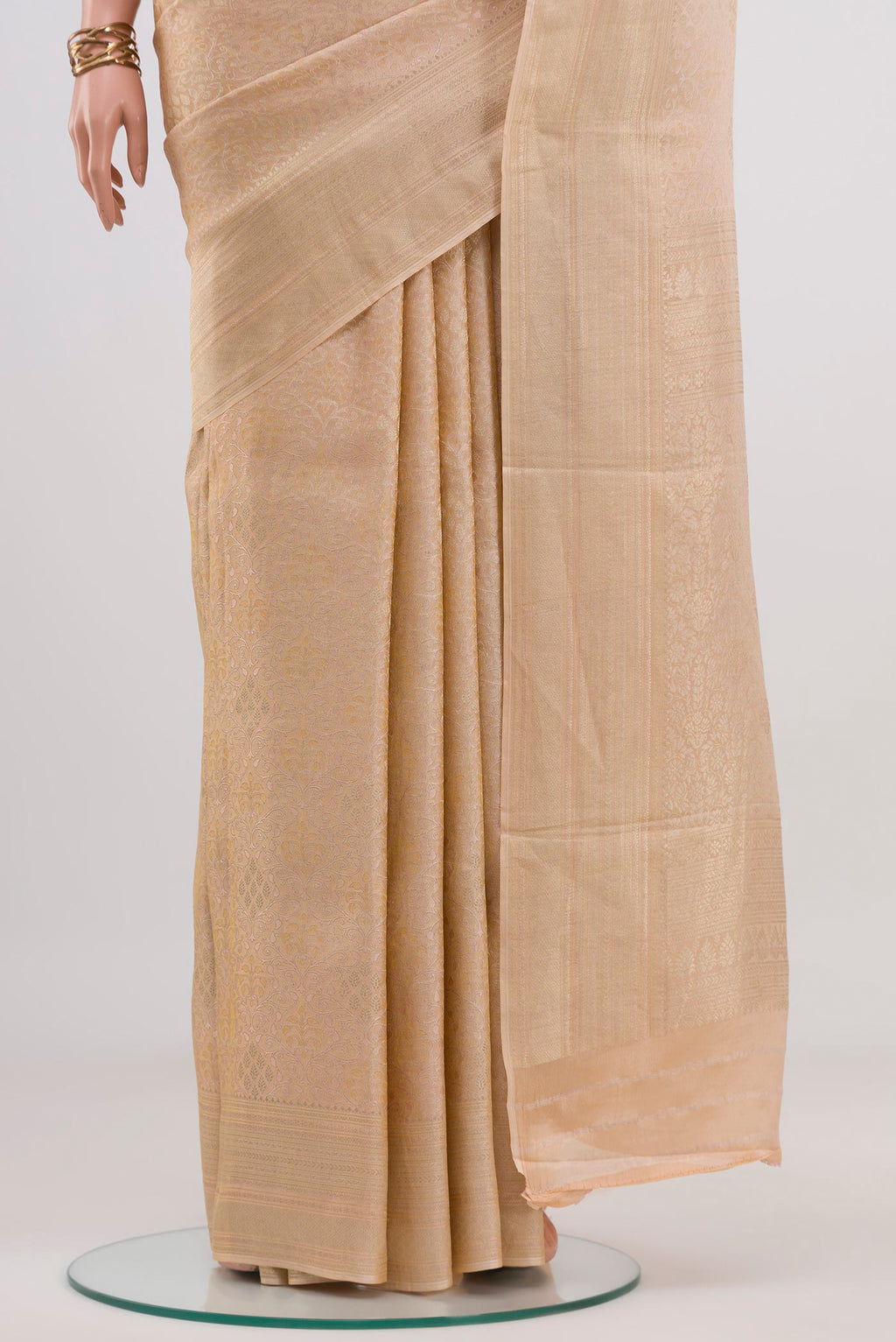Pleats and pallu of Beige Crepe Saree with Fancy on the body and Fancy Border. 