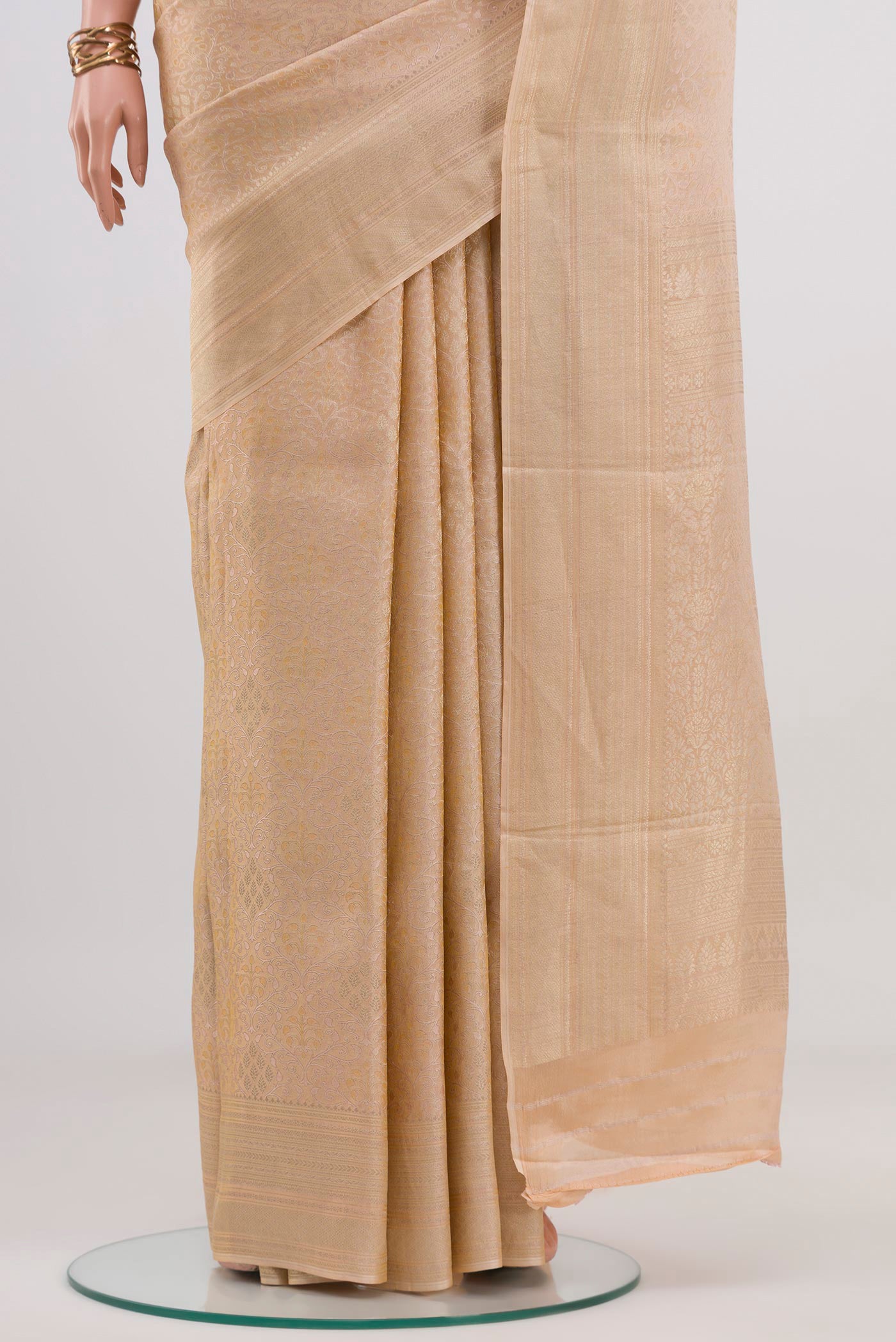 Pleats and pallu of Beige Crepe Saree with Fancy on the body and Fancy Border. 