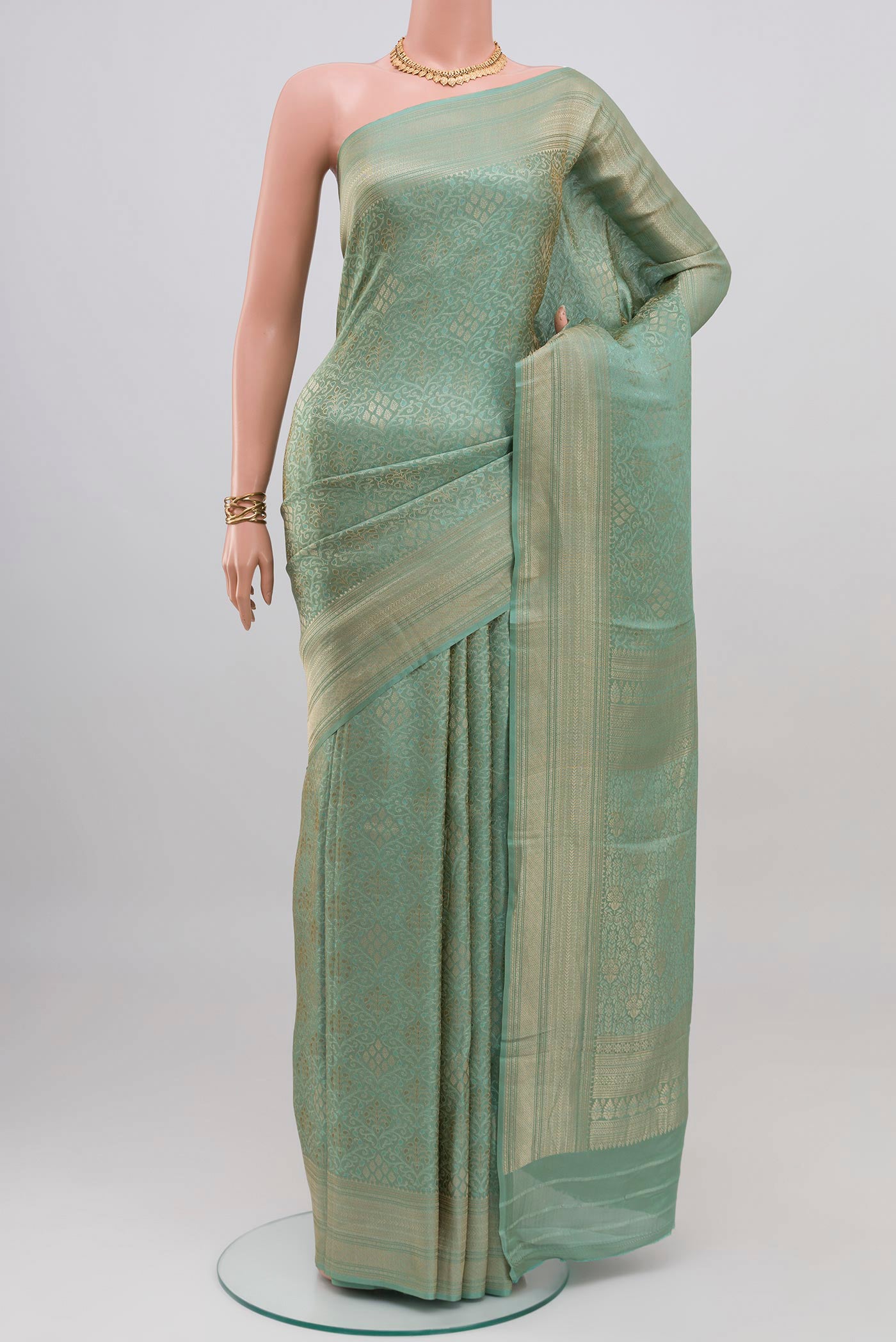 Light Blue Crepe Saree with Zari Brocade on the body and Fancy Border.  displayed on a mannequin