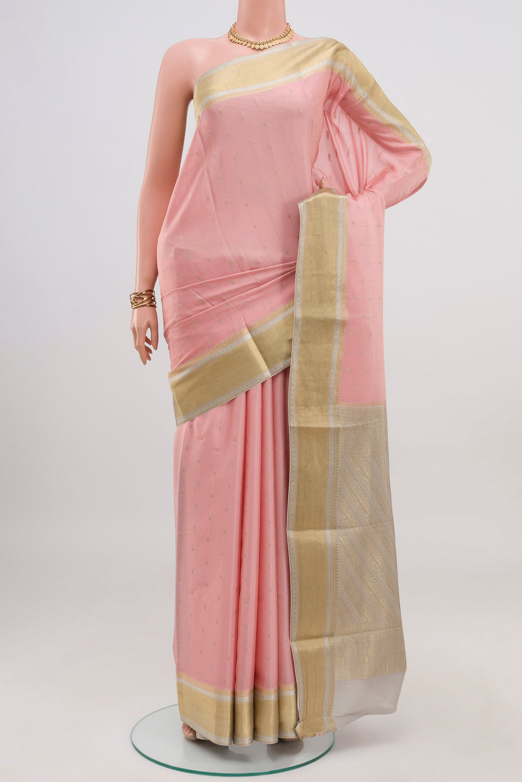 Pink Crepe Saree with Fancy on the body and Zari Border.  displayed on a mannequin