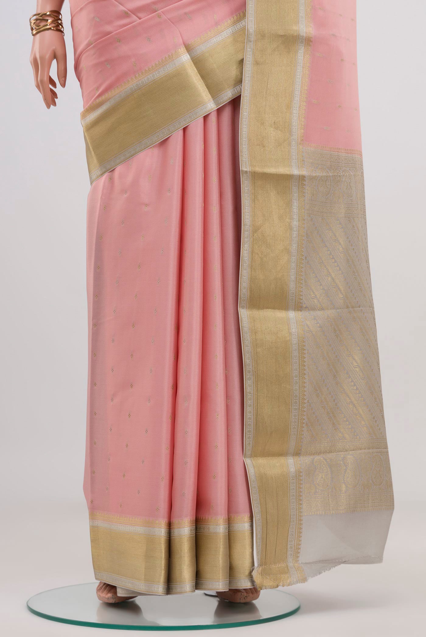 Pleats and pallu of Pink Crepe Saree with Fancy on the body and Zari Border. 