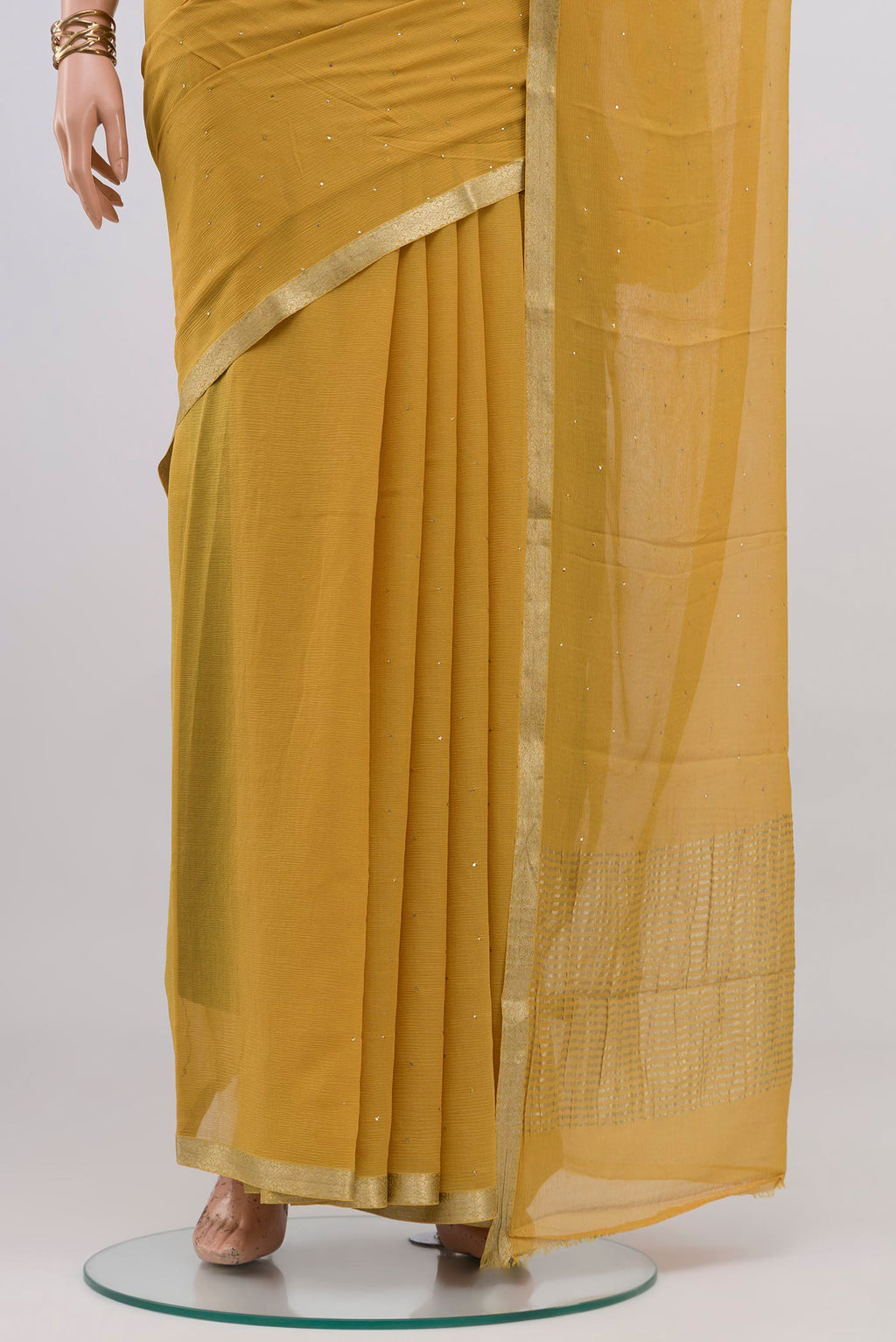 Pleats and pallu of Sandal Mysore Chiffon Saree with Embroidery on the body and Zari Border. 