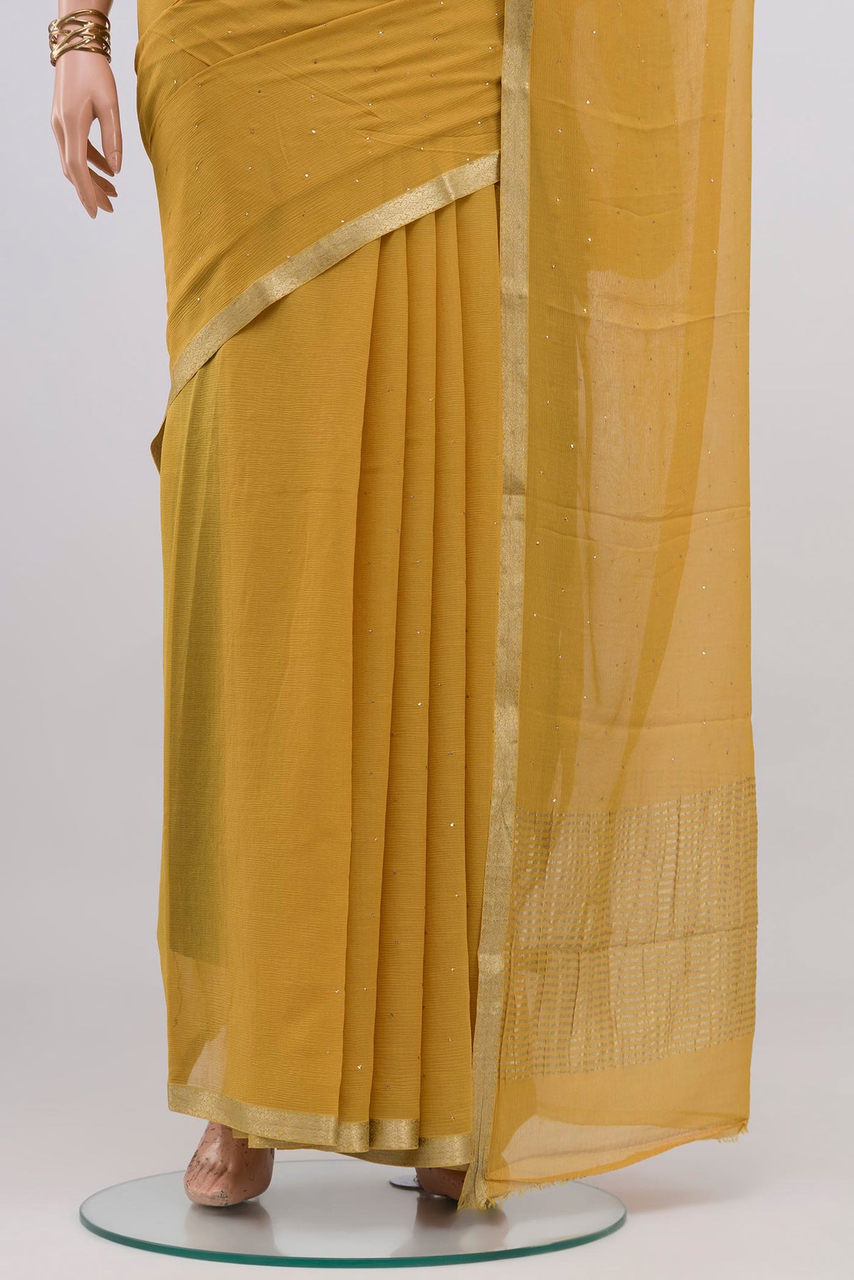 Pleats and pallu of Sandal Mysore Chiffon Saree with Embroidery on the body and Zari Border. 