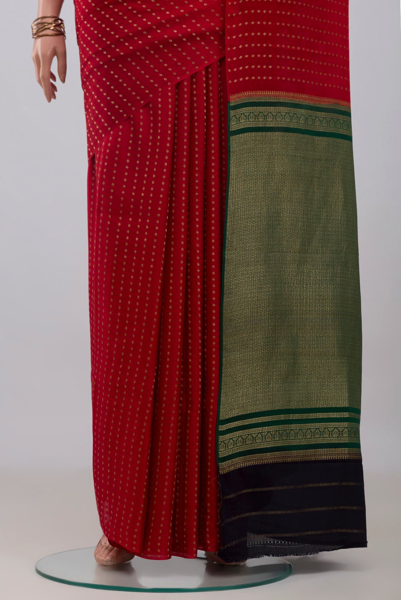 Pleats and pallu of Red Mysore Crepe Saree with Zari Butta on the body and Without Border. 