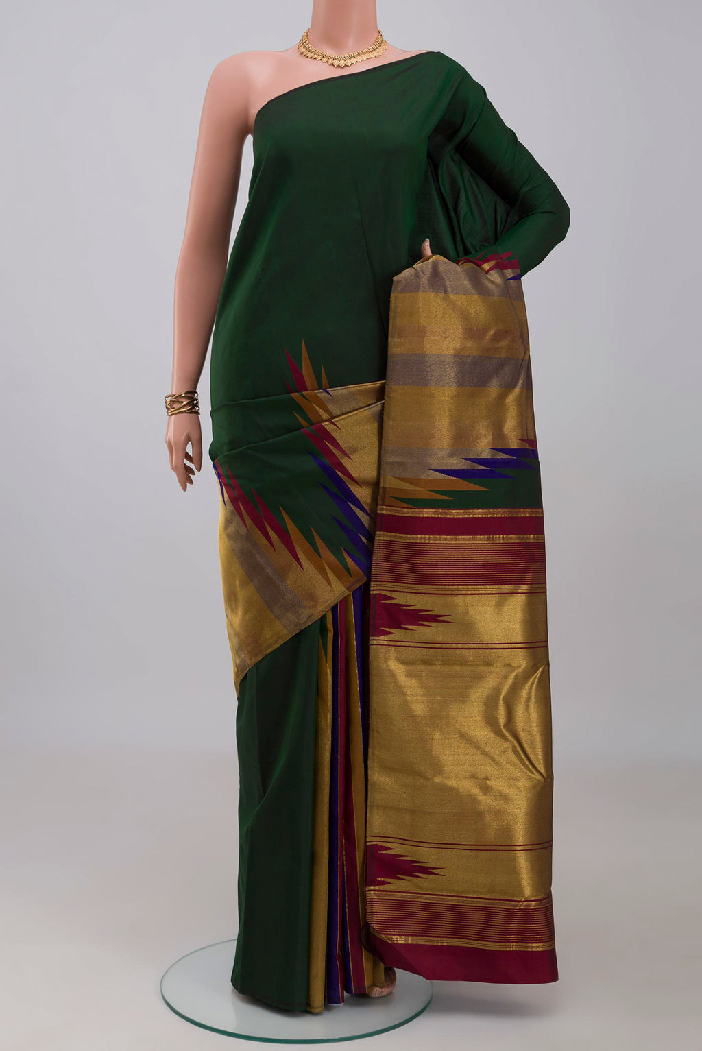 Bottle Green Kanchipuram Silk Saree with Plain Body and Temple Border.  displayed on a mannequin
